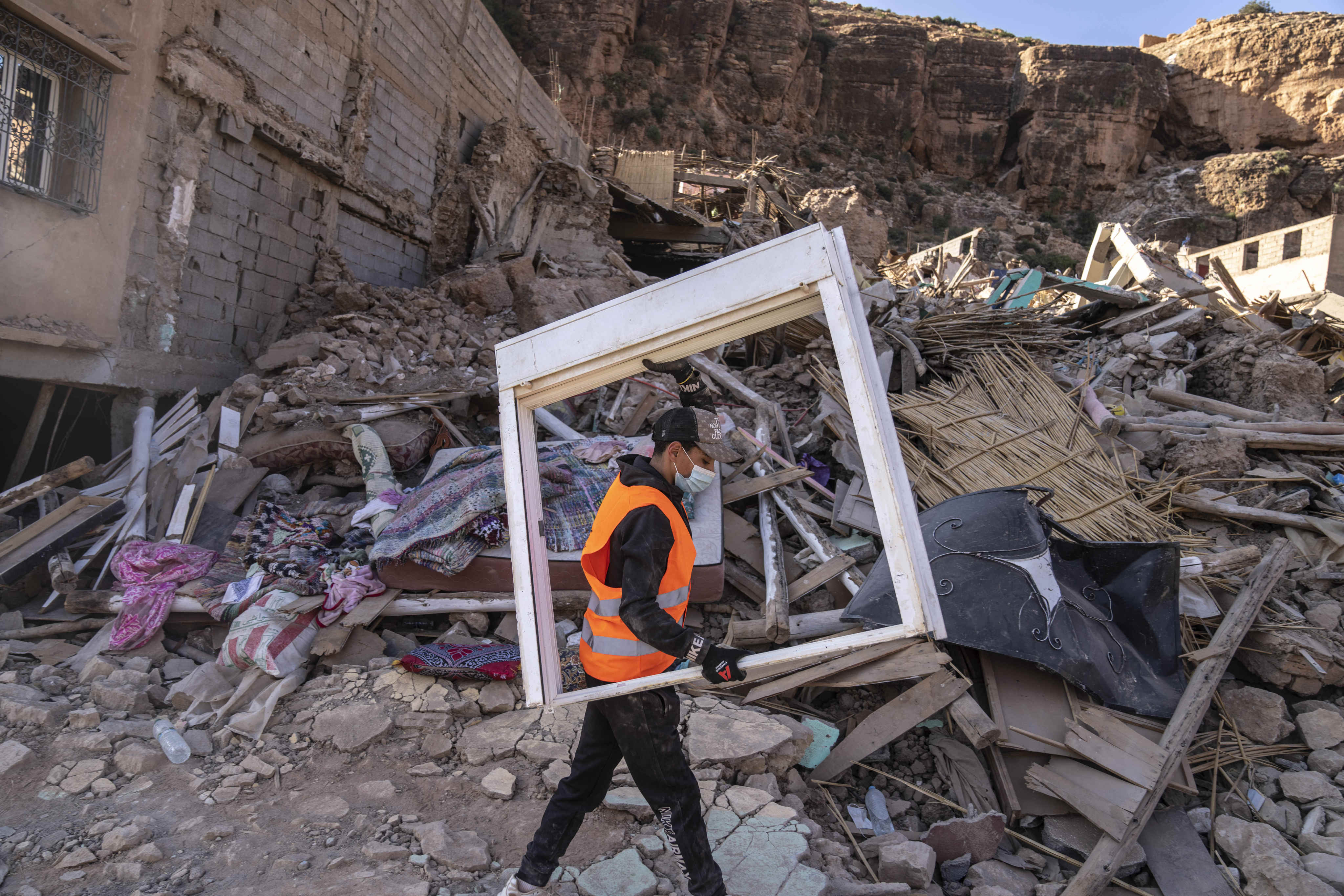 A volunteer salvages furniture from homes damaged by an earthquake in Imi N’tala town outside Marrakech, Morocco, on September 13. Photo: AP