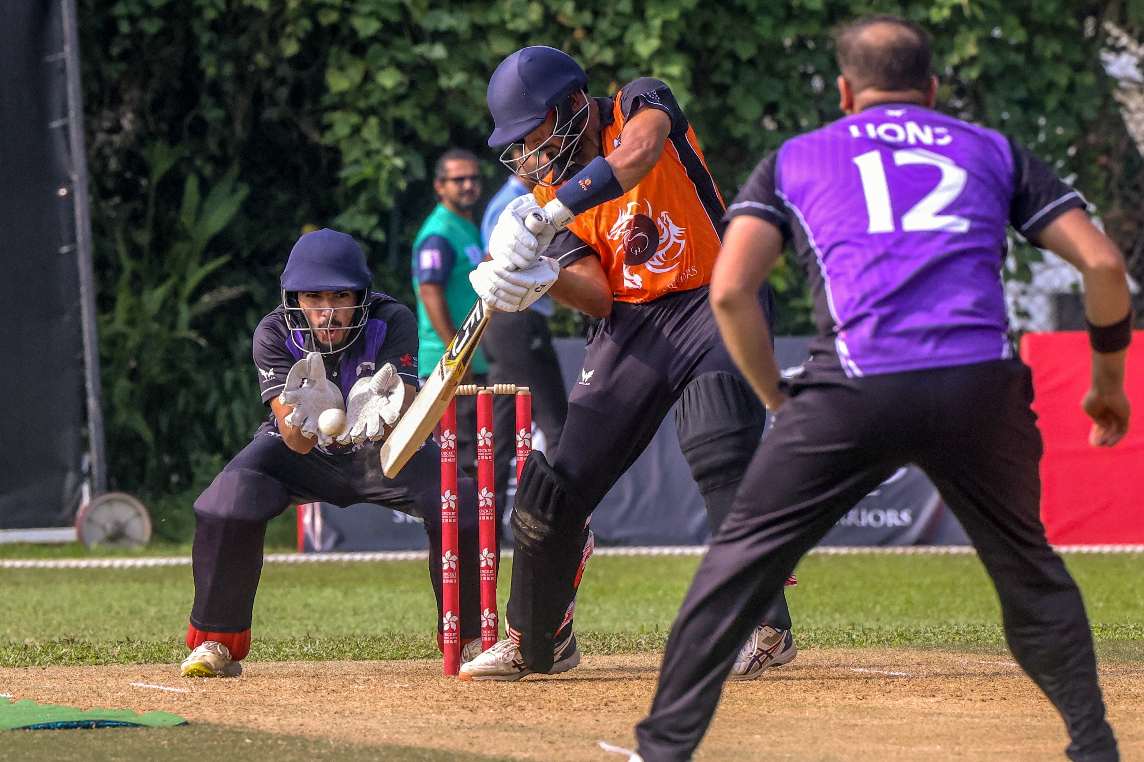 Lions wicketkeeper Shahid Wasif looks on as Tigers’ Nizakat Khan hits Yasim Murtaza to the off side. Photo: Jonathan Wong