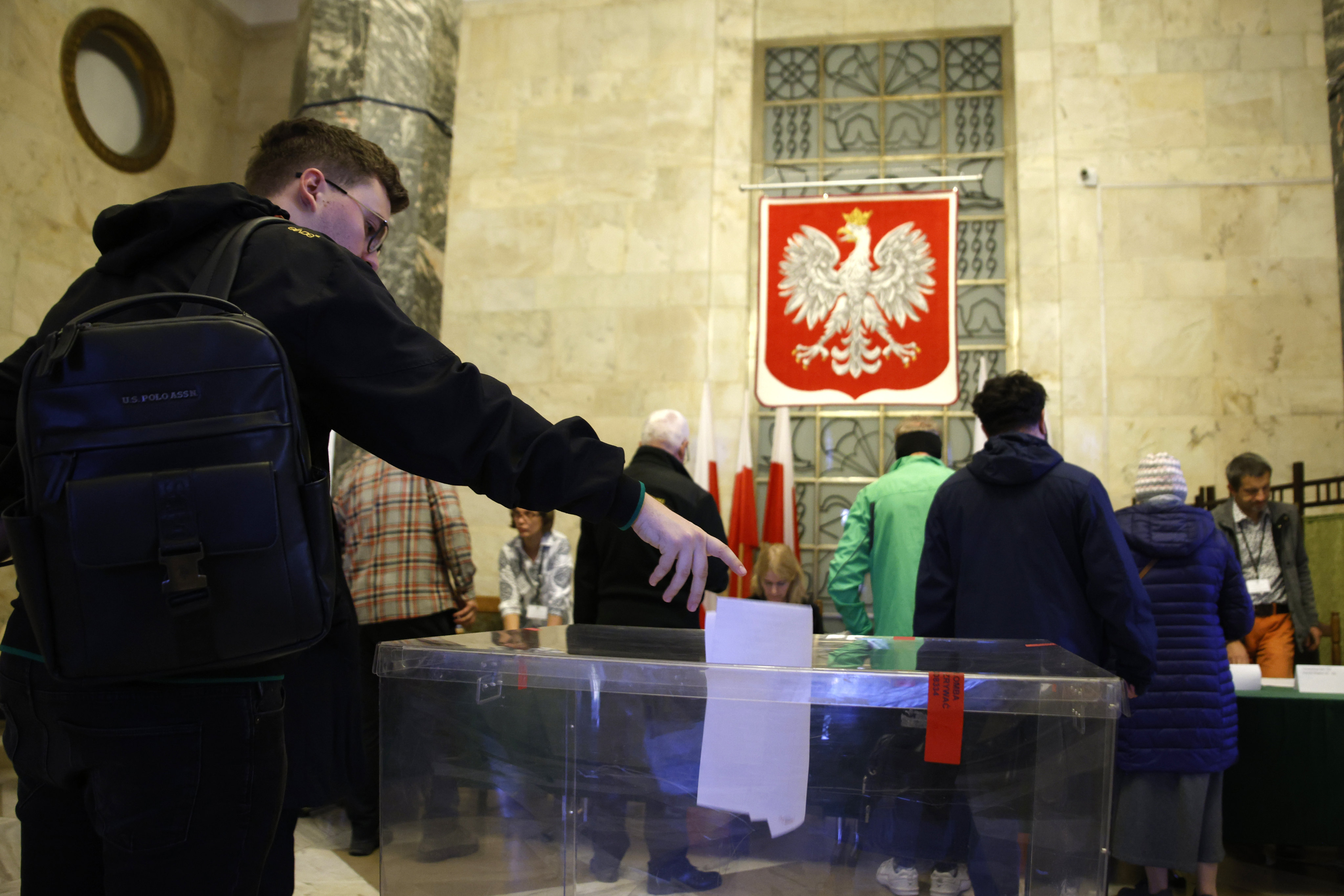 Polish residents voting in parliamentary elections in Warsaw on Sunday. Photo: AP