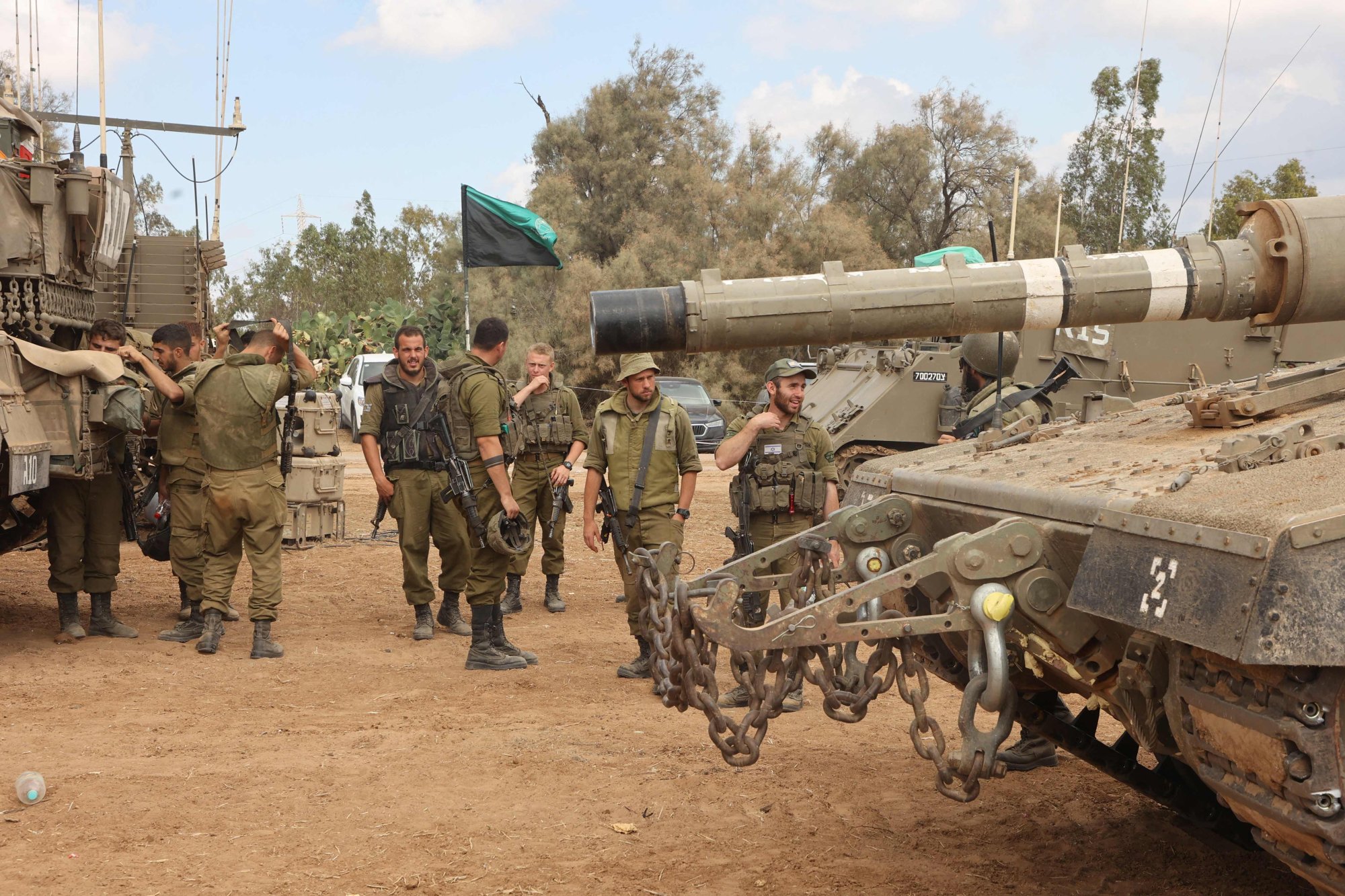 Israeli troops prepare weapons and armed vehicles near the southern city of Ashkelon on Sunday. Photo: AFP