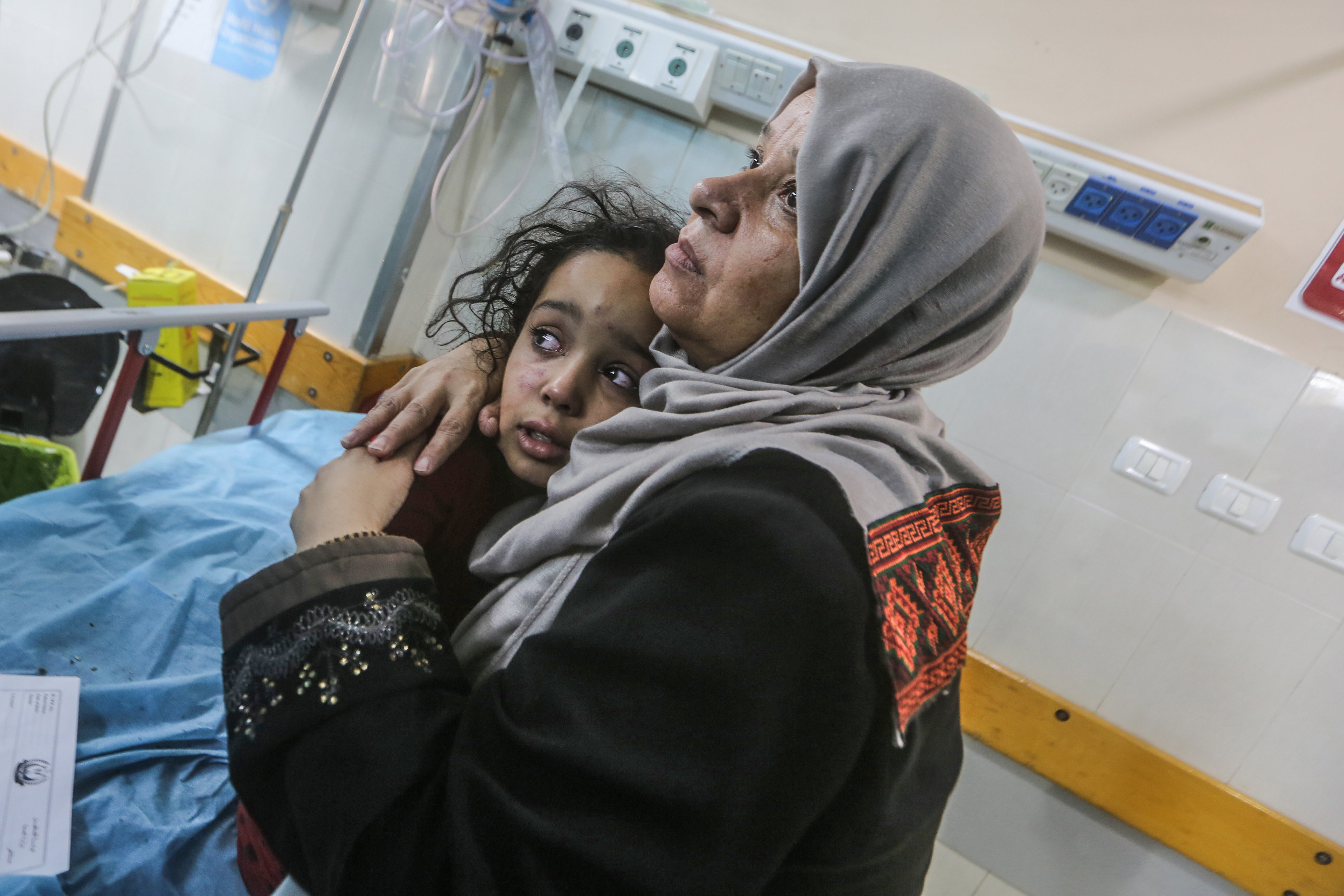 A mother comforts her injured child at Nasser Hospital on Wednesday after air strikes at Khan Yunis in the southern Gaza Strip. Photo: dpa