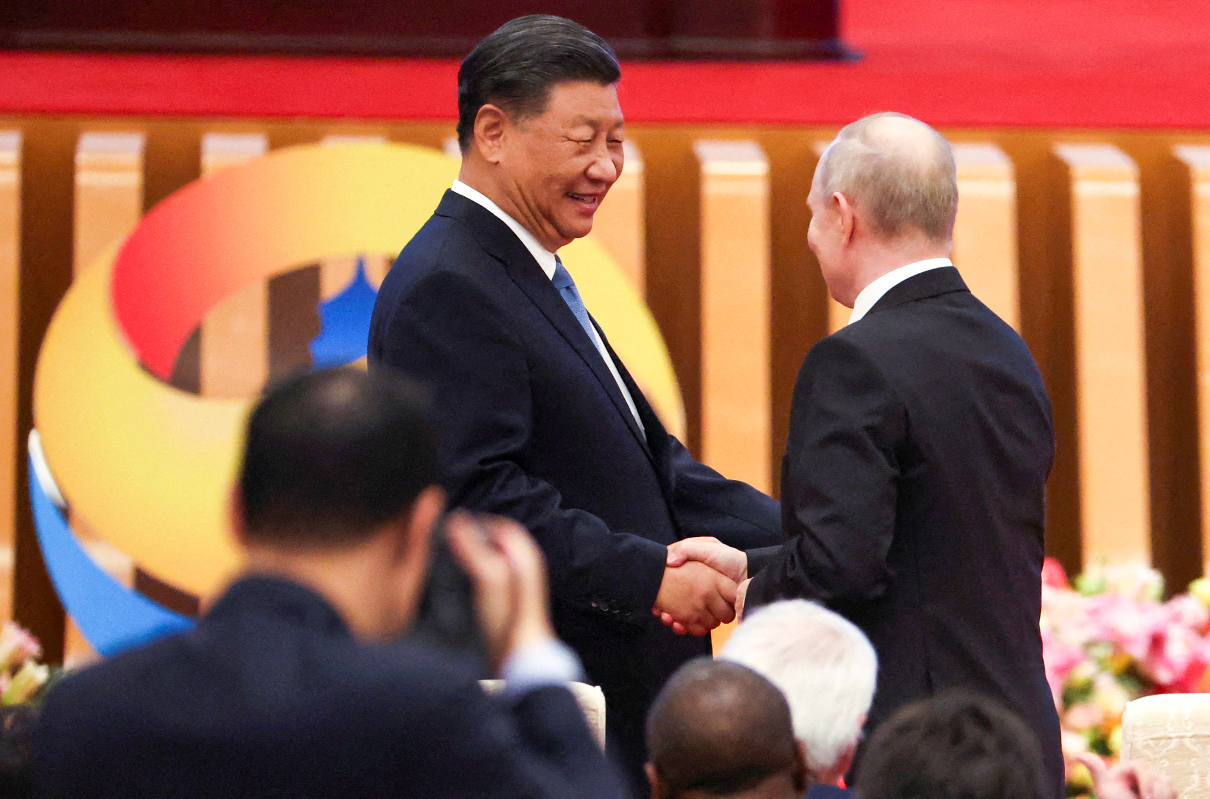 Xi Jinping greets Vladimir Putin at the belt and road forum in Beijing on Wednesday. Photo: Reuters
