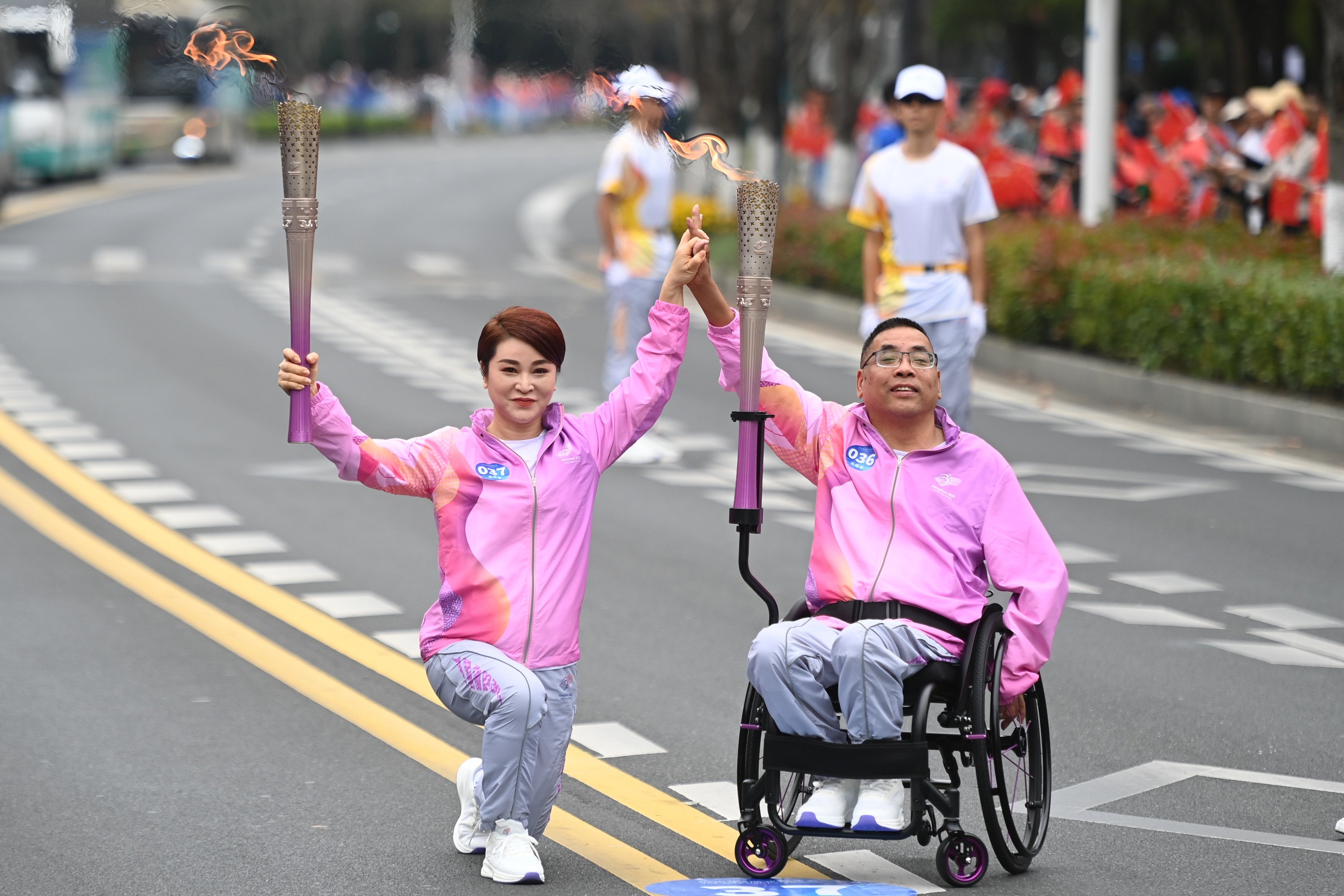 Torch bearers pose during the torch relay for the 4th Asian Para Games. Photo: Xinhua