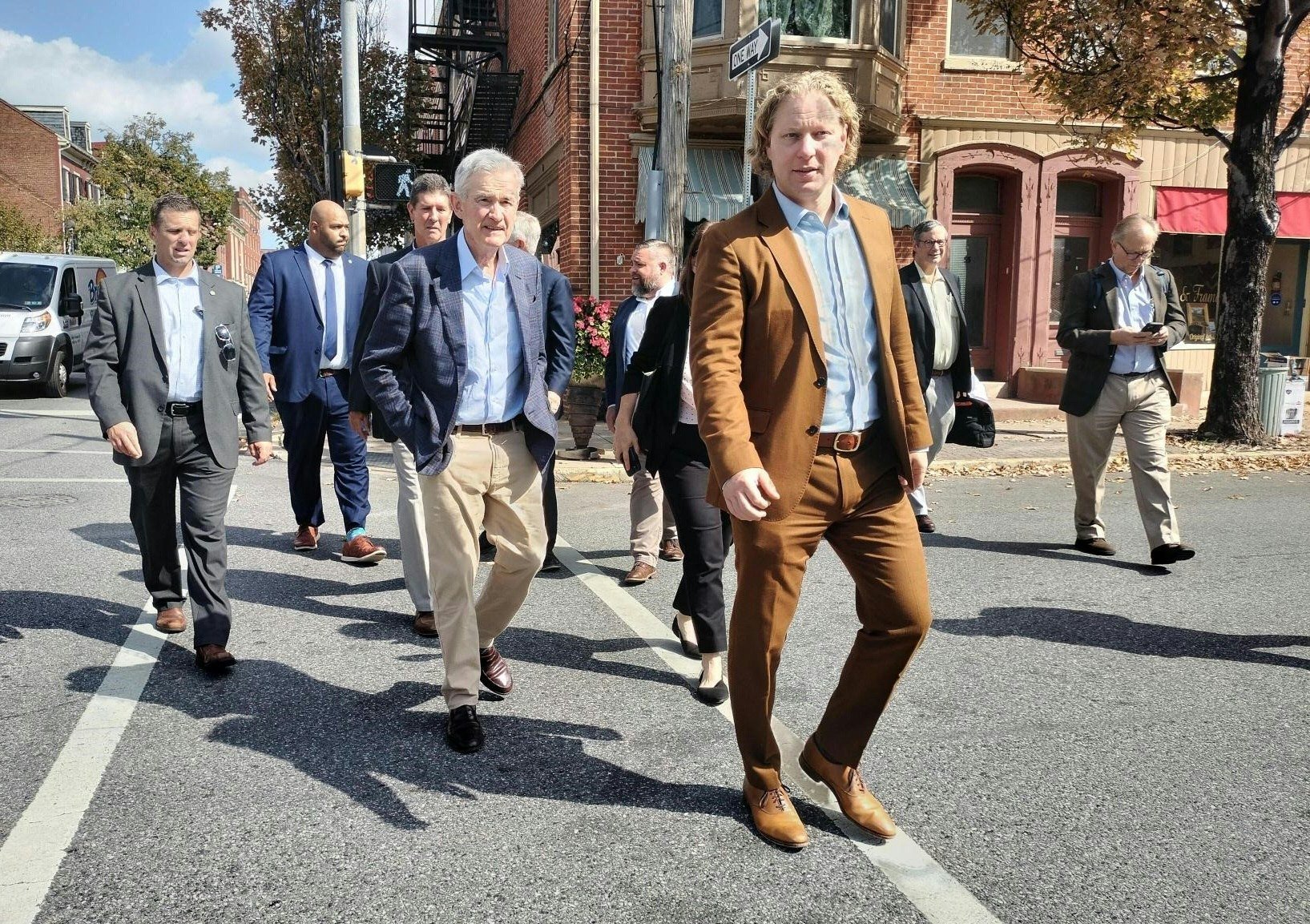 US Federal Reserve chairman Jerome Powell (centre) and Kevin Schreiber (foreground), president of the York County Economic Alliance, walk down the street during a visit to York, Pennsylvania, on October 2, to meet local economic players. Photo: AFP 