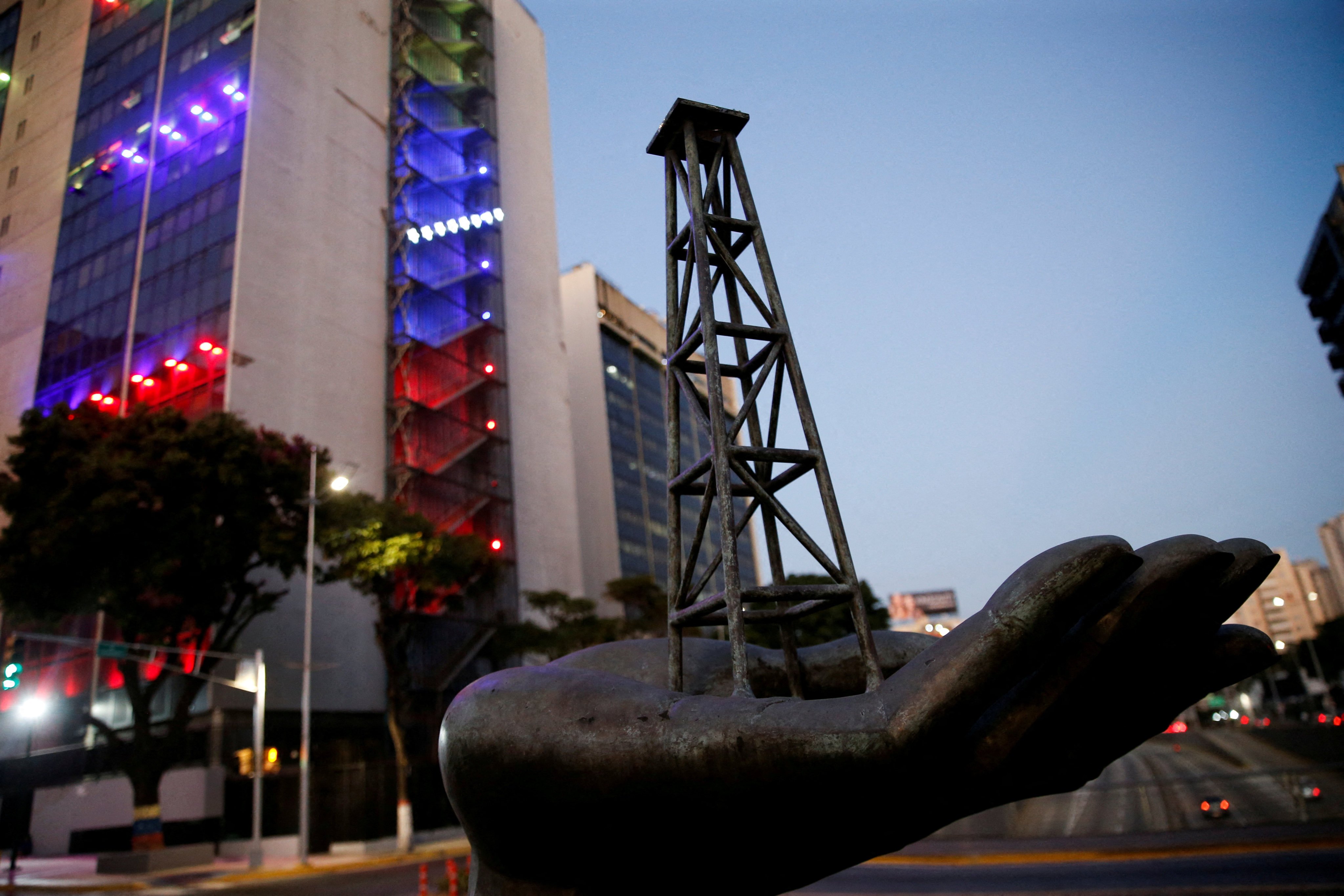 A sculpture depicting an oil tower on a hand of Venezuela’s state oil company PDVSA, near the company’s headquarters, in Caracas. Photo: Reuters