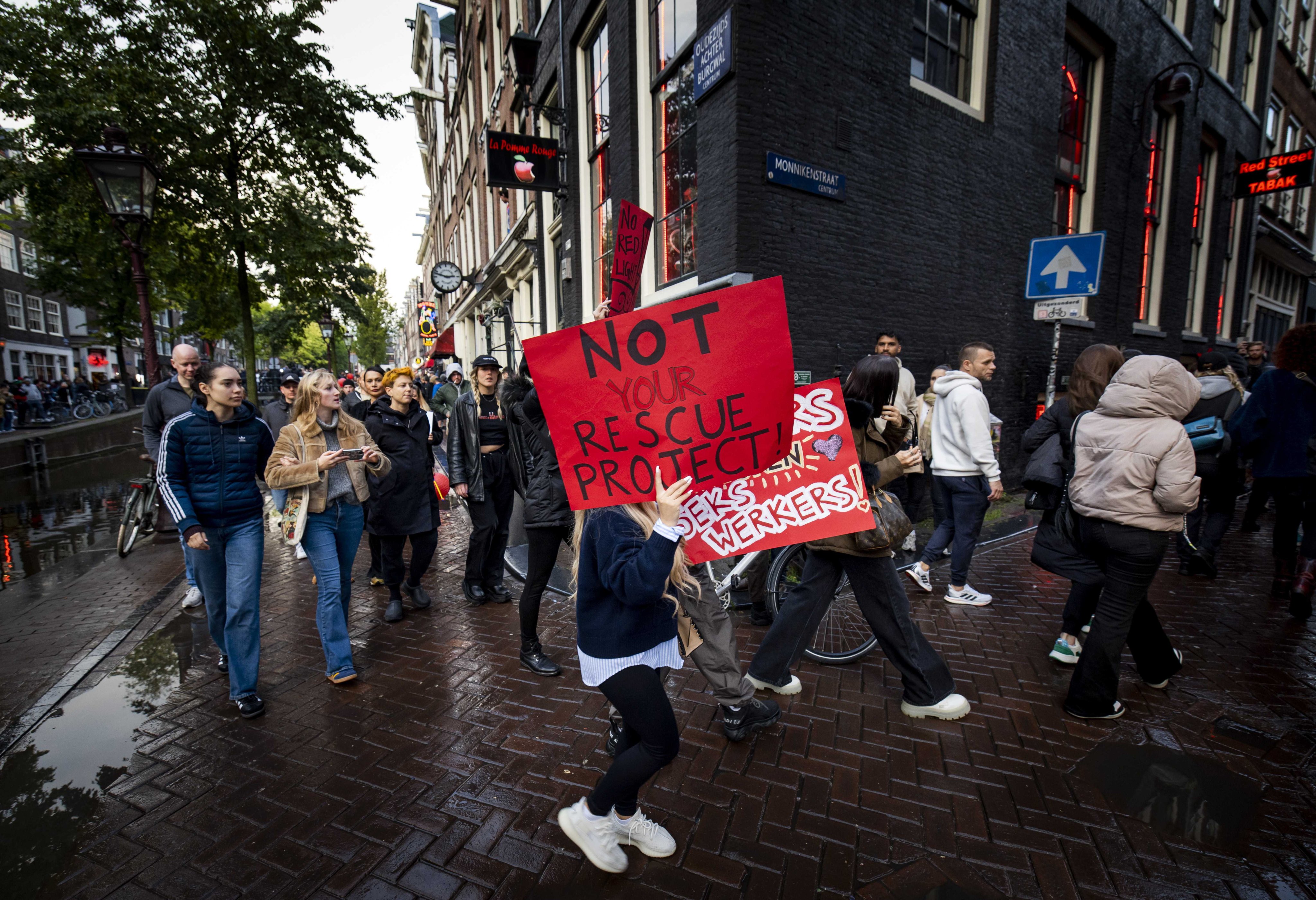 Demonstrators hold placards during a parade through Amsterdam on Thursday. Photo: EPA-EFE