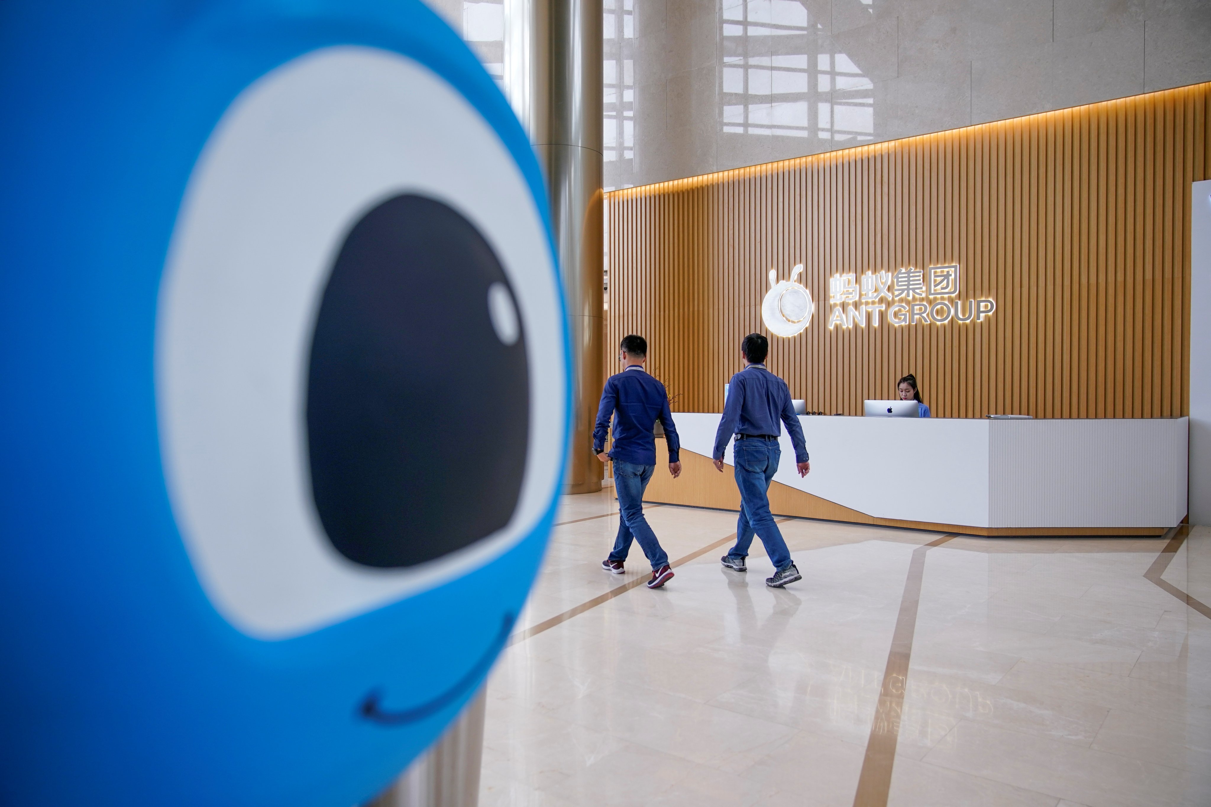 Employees walk through the lobby of Ant Group headquarters in Hangzhou, China, on October 29, 2020. Photo: Reuters