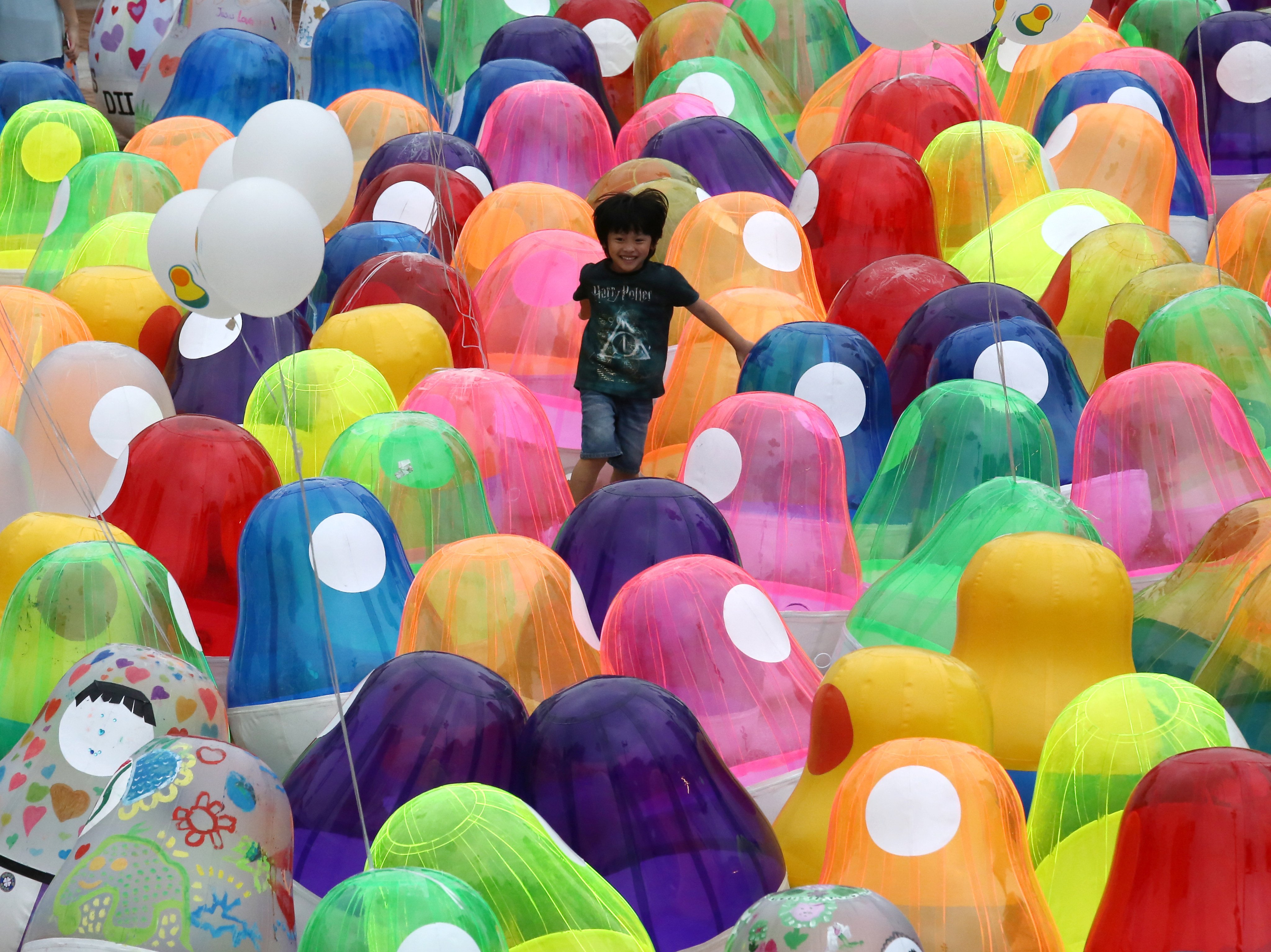 A child plays among Roly-poly toys at Kowloon Park in Tsim Sha Tsui on April 27, 2019, as part of a display meant to raise public awareness of students’ mental health. Photo: Jonathan Wong