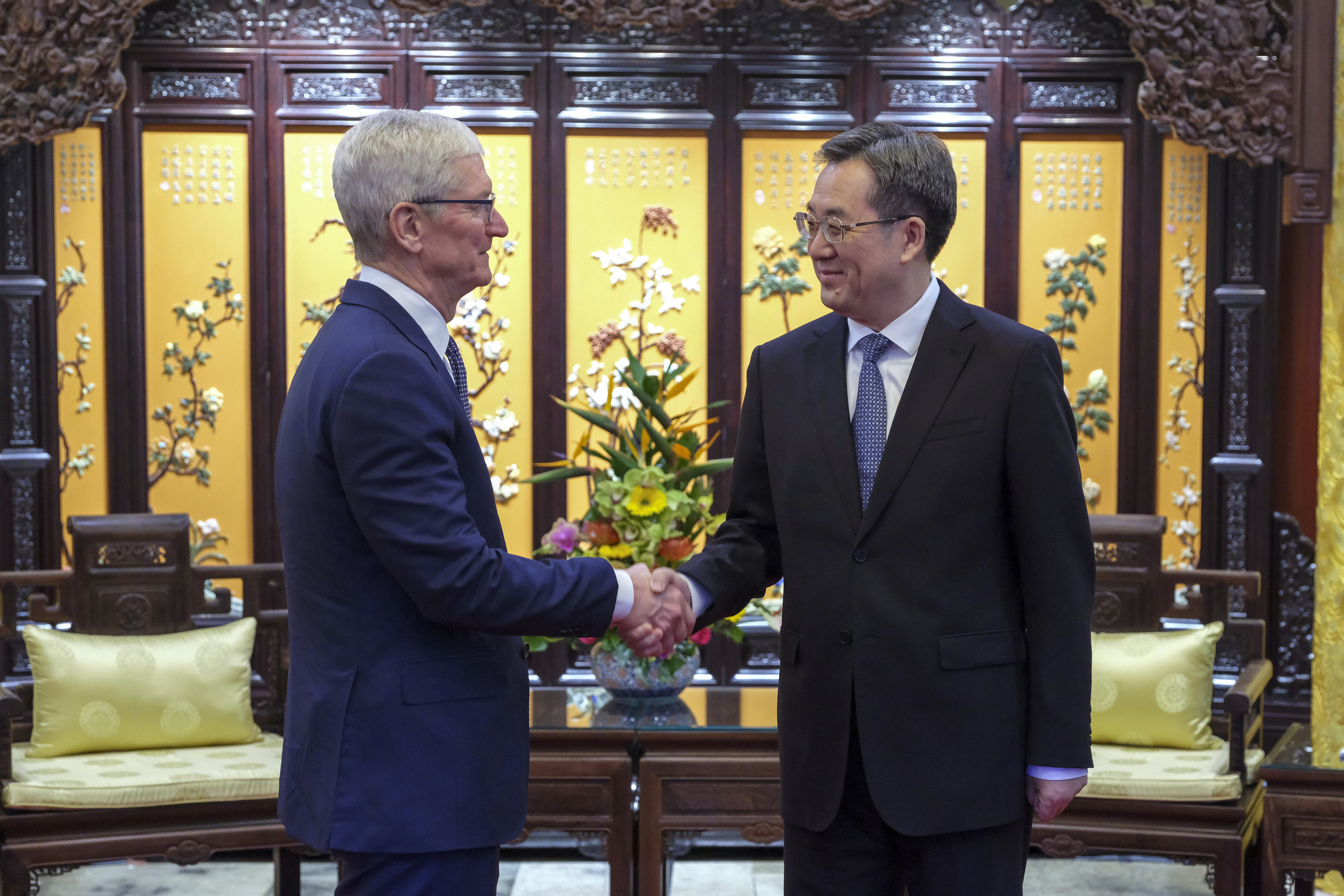 Apple CEO Tim Cook, left, greets Chinese Vice-Premier Ding Xuexiang in Beijing on October 19, 2023. Photo: Xinhua via AP