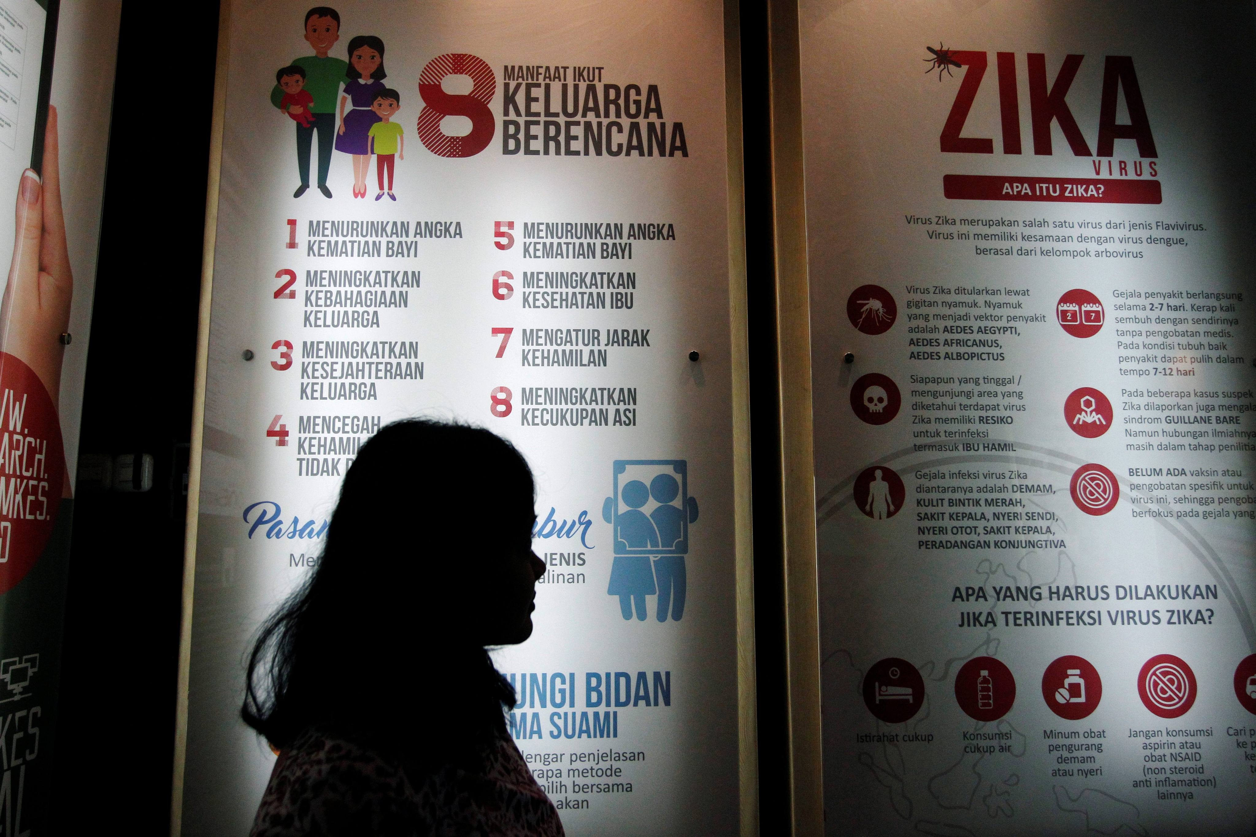 A woman stands near a poster about the Zika virus at the ministry of health office in Jakarta, Indonesia, in September 2016. Photo: Reuters