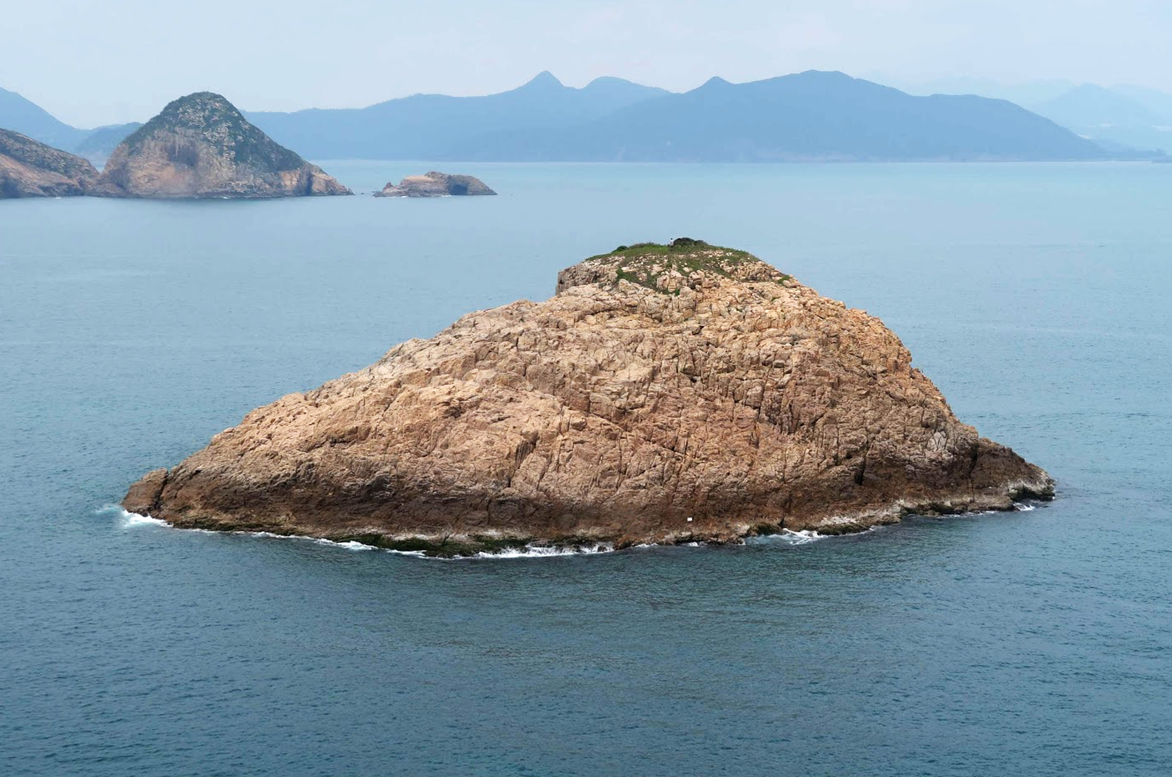 Marine police found nine men along rocky shoreline of Shue Long Chau. Photo: Handout