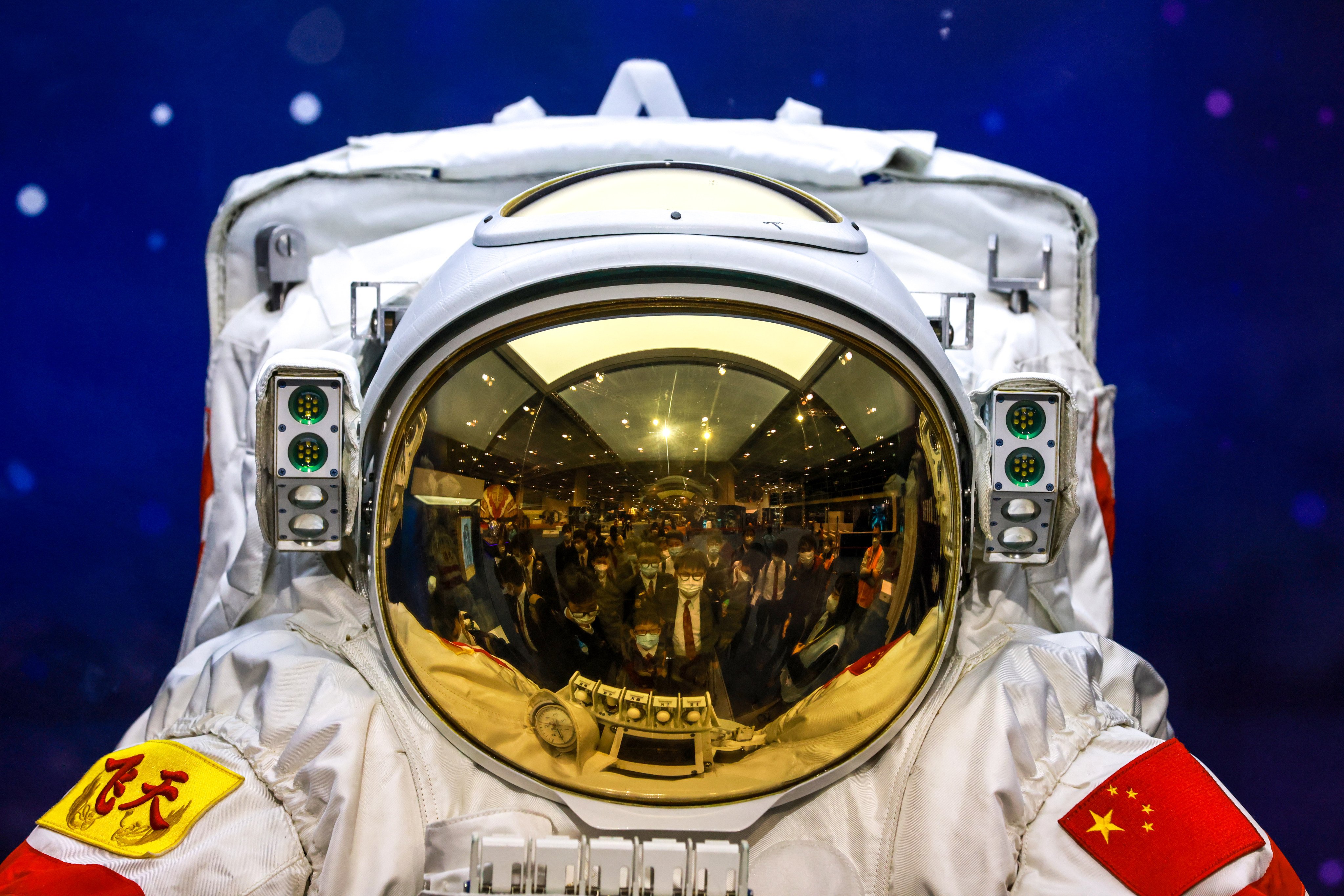 The reflection from an astronaut’s shield shows students visiting the InnoTech Expo at Hong Kong Convention and Exhibition Centre in Wan Chai on December 12 last year. Photo: May Tse
