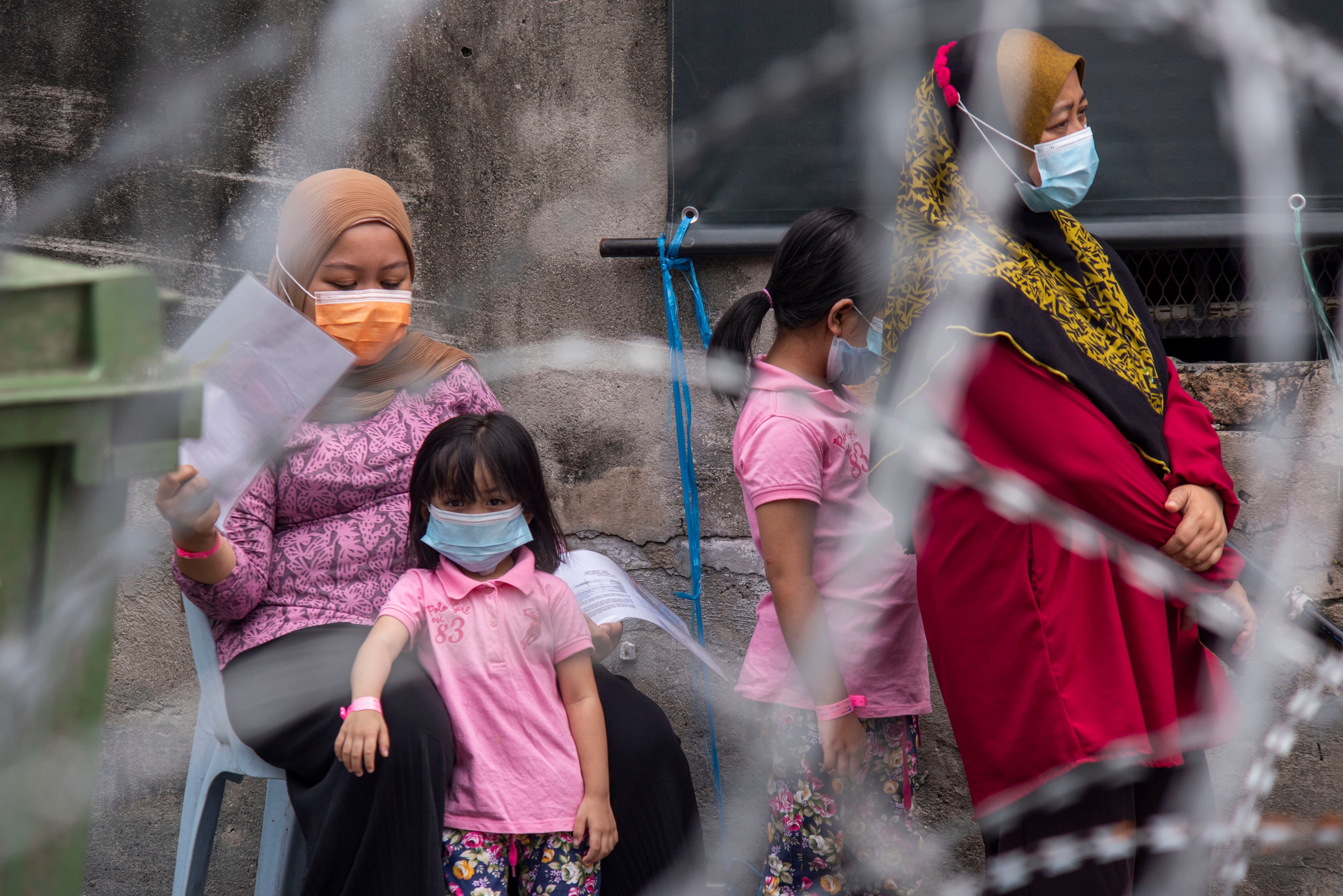 Children wait with their carers for nasal swab tests in an area of Kuala Lumpur under Covid lockdown in July 2021. The pandemic had exposed constraints on Malaysia’s mental-health professionals, the country’s health minister said. Photo: Xinhua