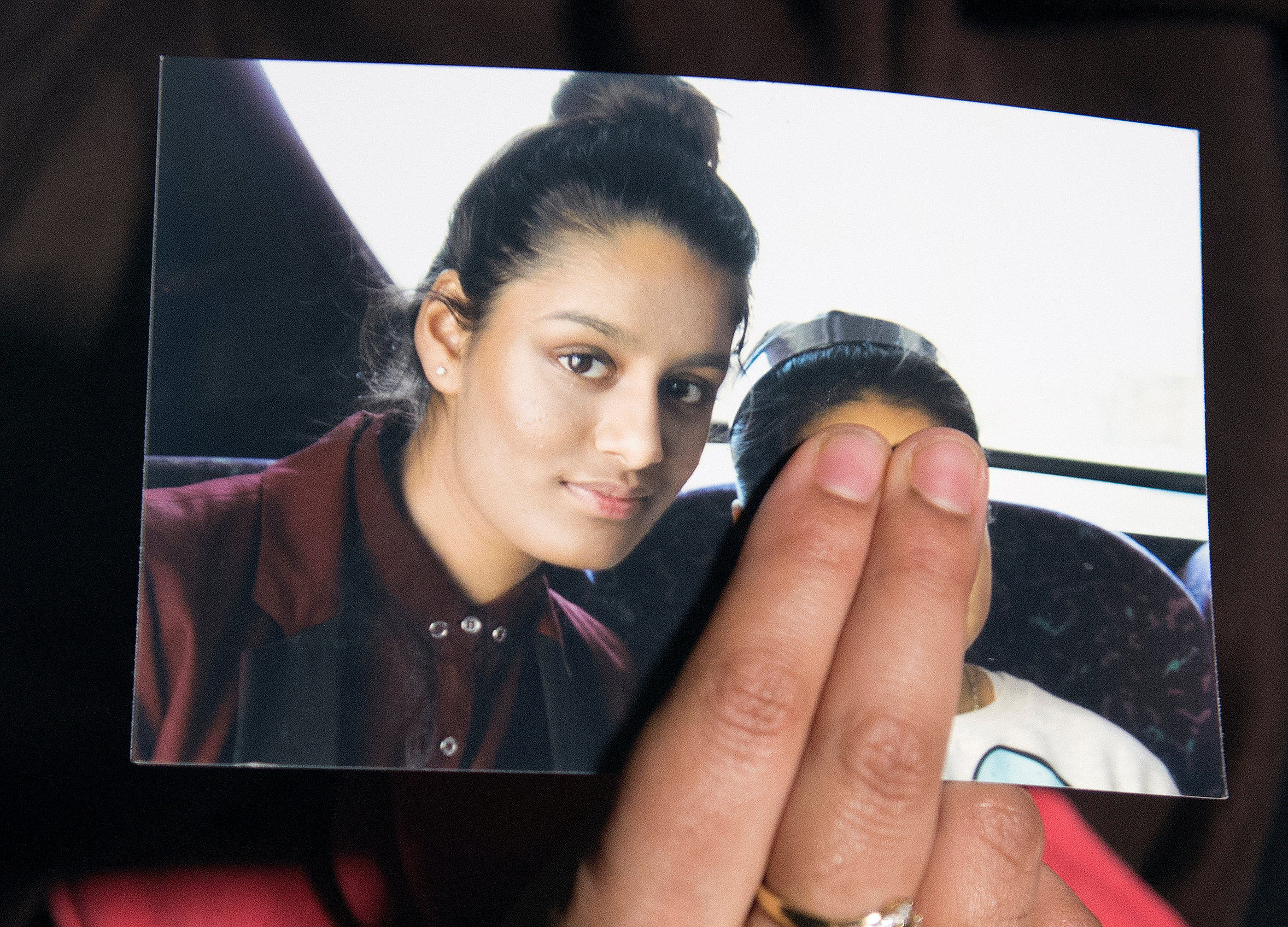 Renu Begum, sister of teenage British girl Shamima Begum, holds a photo of her sister as she makes an appeal to have her British citizenship renewed. Photo: Reuters