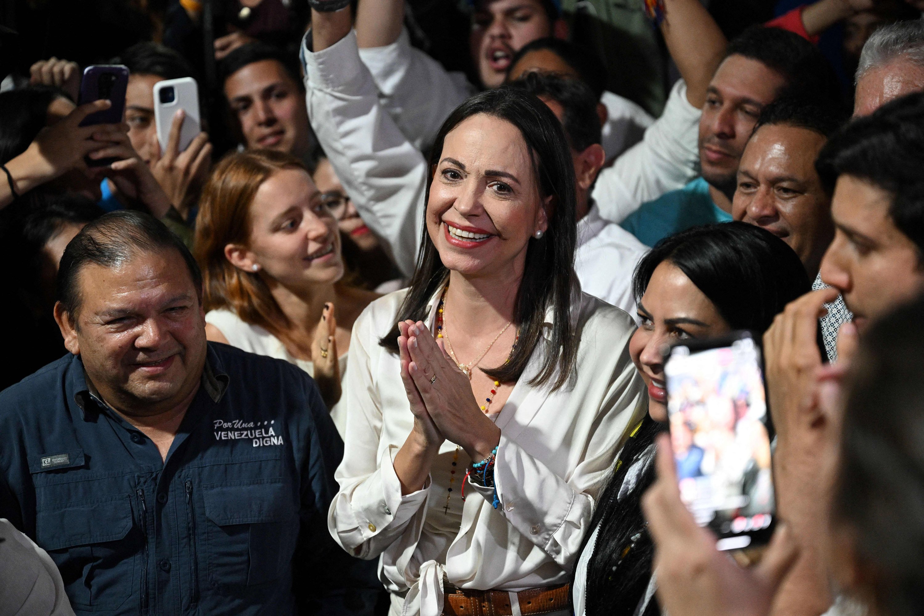 Venezuela’s Maria Corina Machado, centre, celebrates the results of the opposition’s primary elections at her party headquarters in Caracas, Venezuela on Monday. Photo:  AFP / Getty Images / TNS