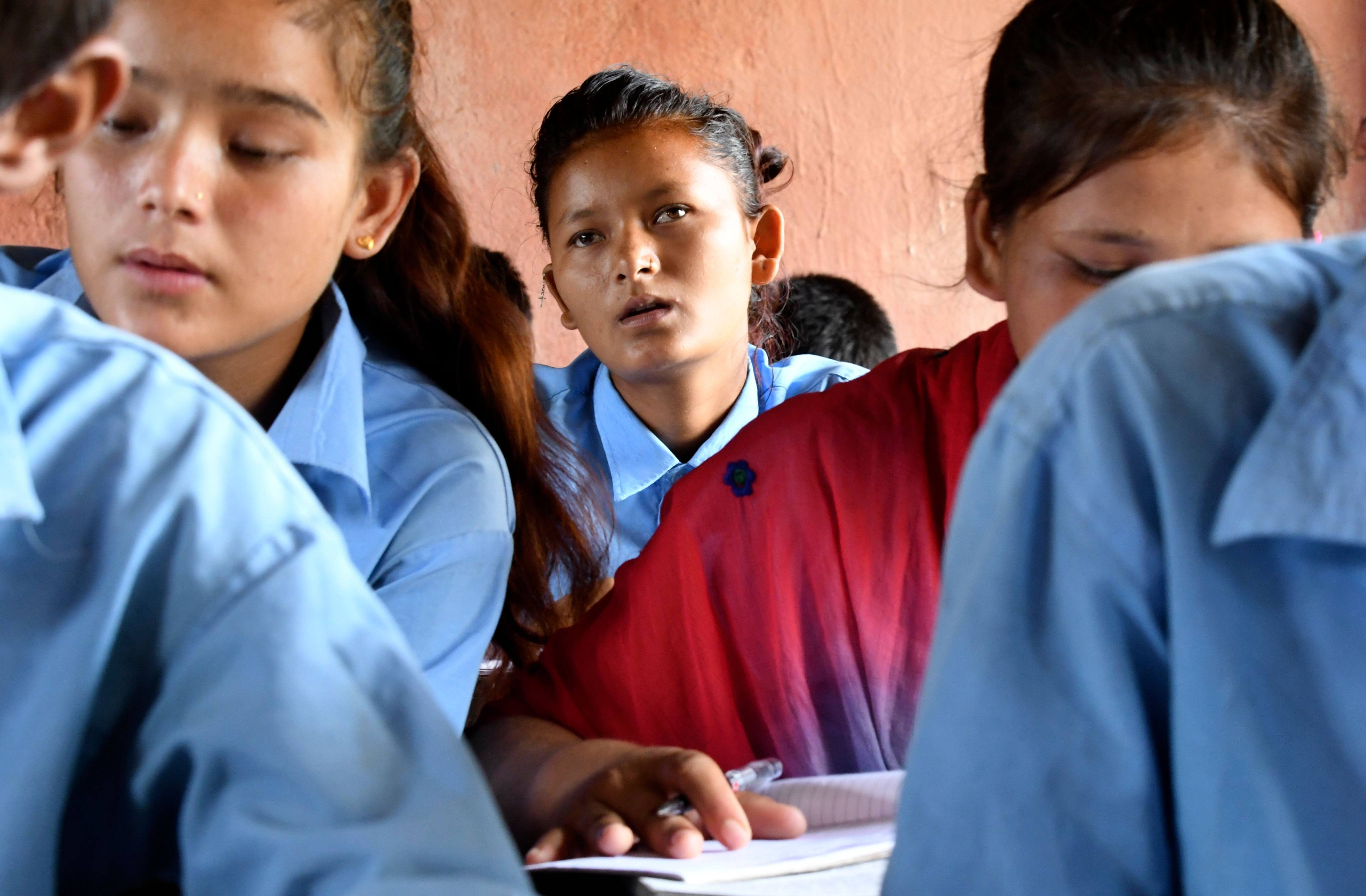 A child marriage survivor attends school in Barahatal in Surkhet district in Nepal in 2019. Child marriage can have an intergenerational impact; girls who marry young tend to attain lower levels of education, and so might their children. Photo: AFP 
