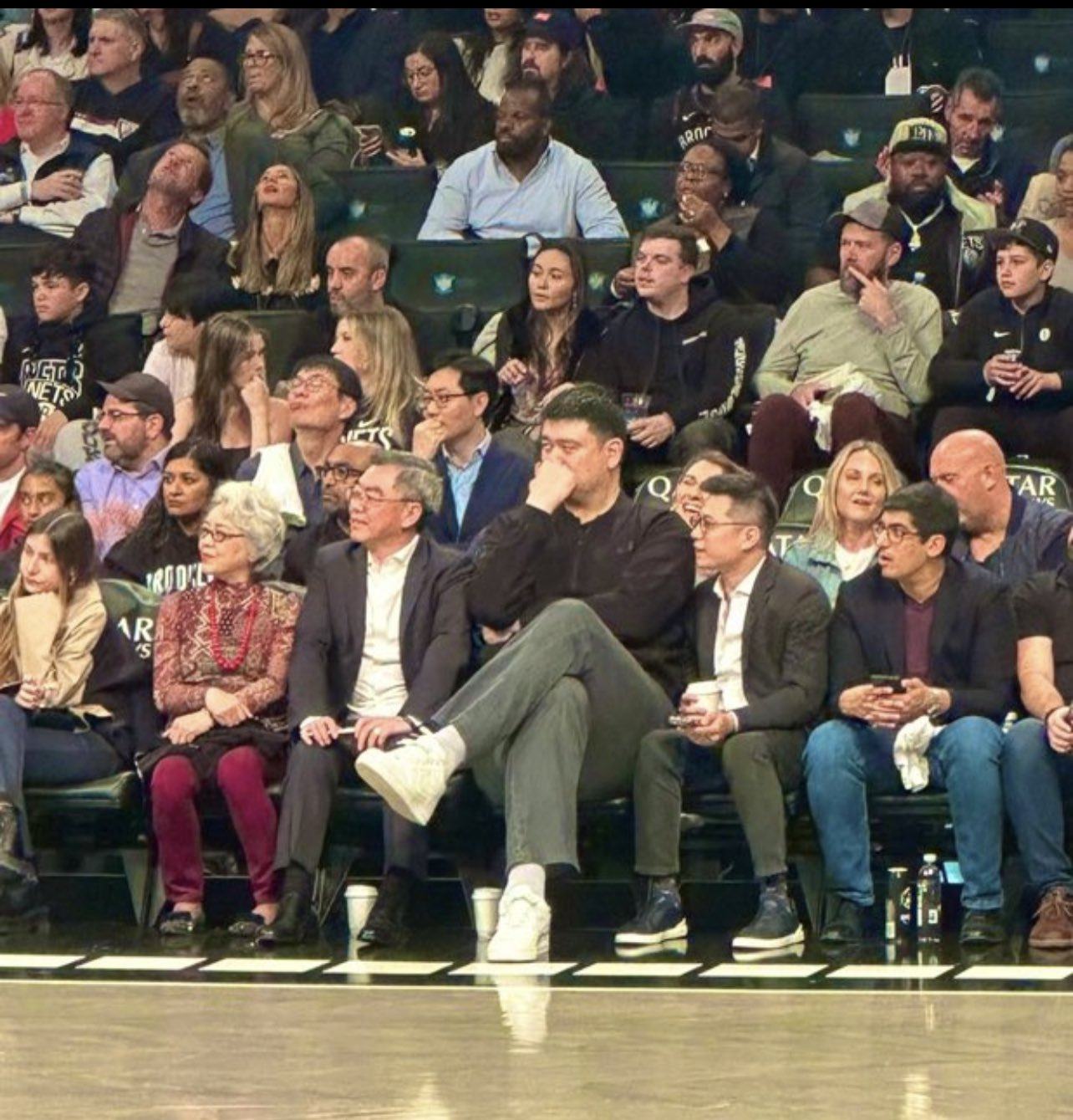 Yao Ming casts a towering figure as he sits courtside at the Barclays Centre. Photo: X/@BusterScher