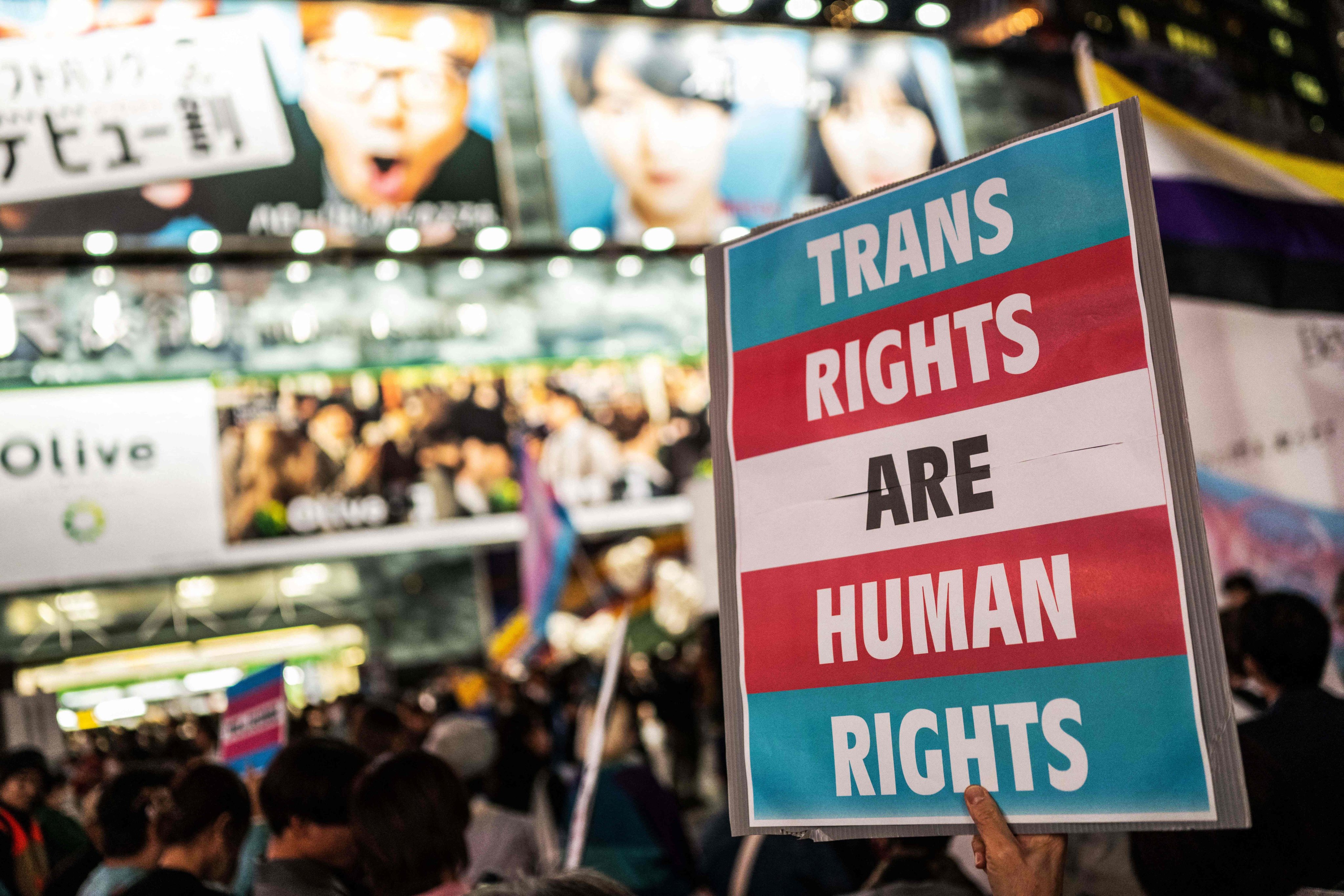 A participant holds up a placard during the International Transgender Day of Visibility rally in Shibuya district of Tokyo in March. Photo: AFP