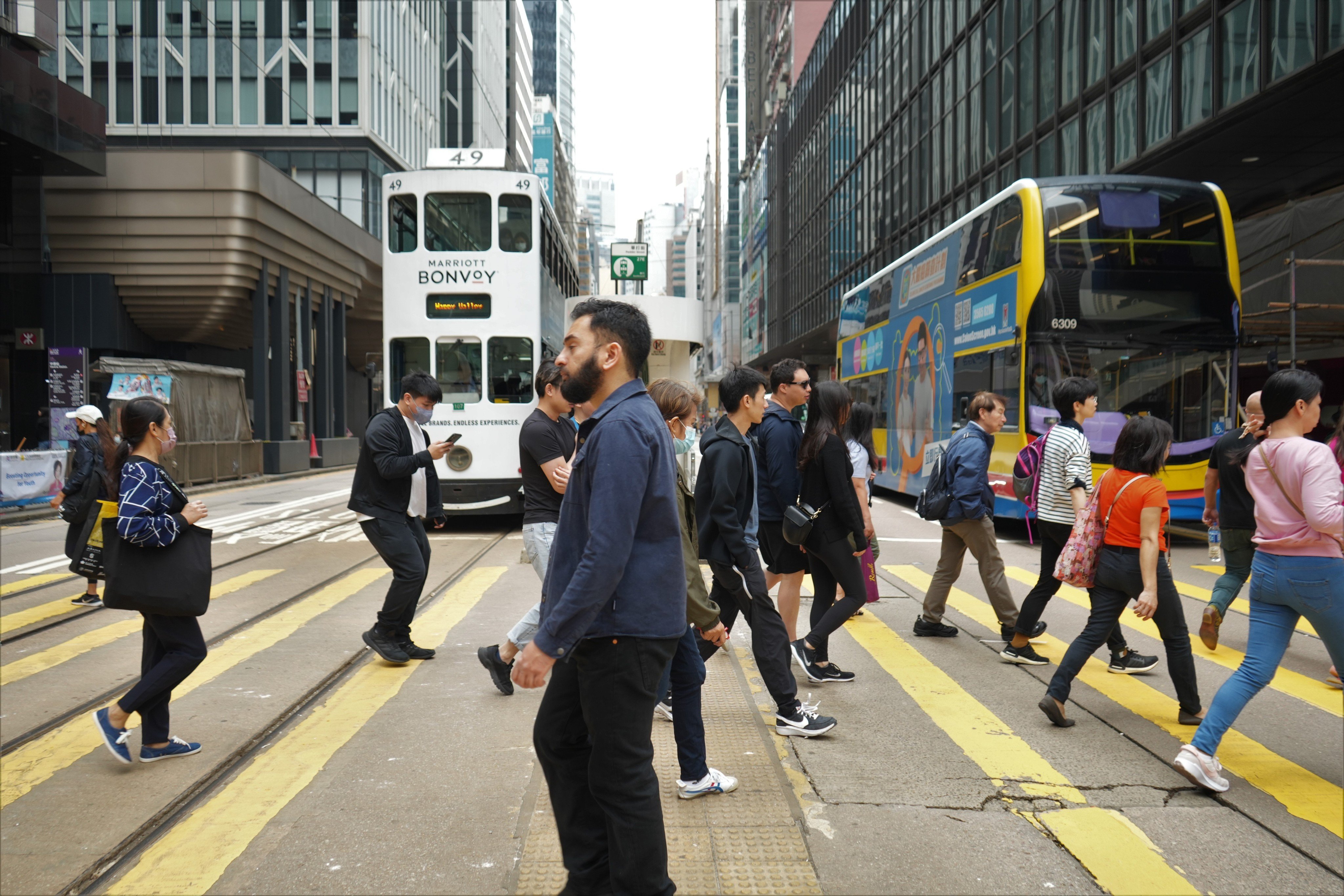 People cross a road in Central, Hong Kong. Is casual racism accepted as a small price to pay for a life in a city envied by much of Asia for its high standard of living? Photo: Shutterstock