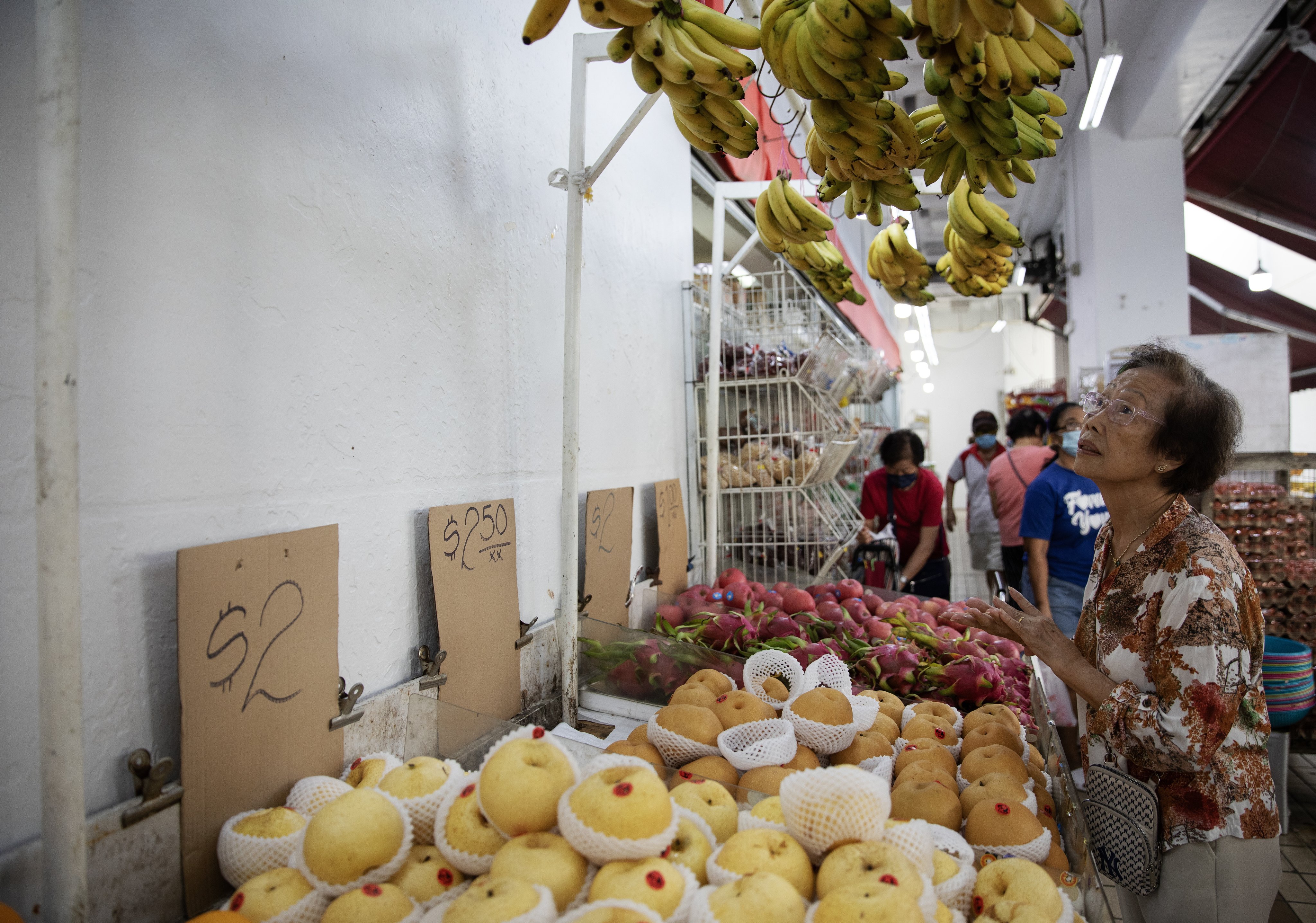 A woman looks at bananas on display at a market in Singapore on October 24. Asia’s economic fundamentals are much stronger than they were a decade ago, at least. Photo: EPA-EFE