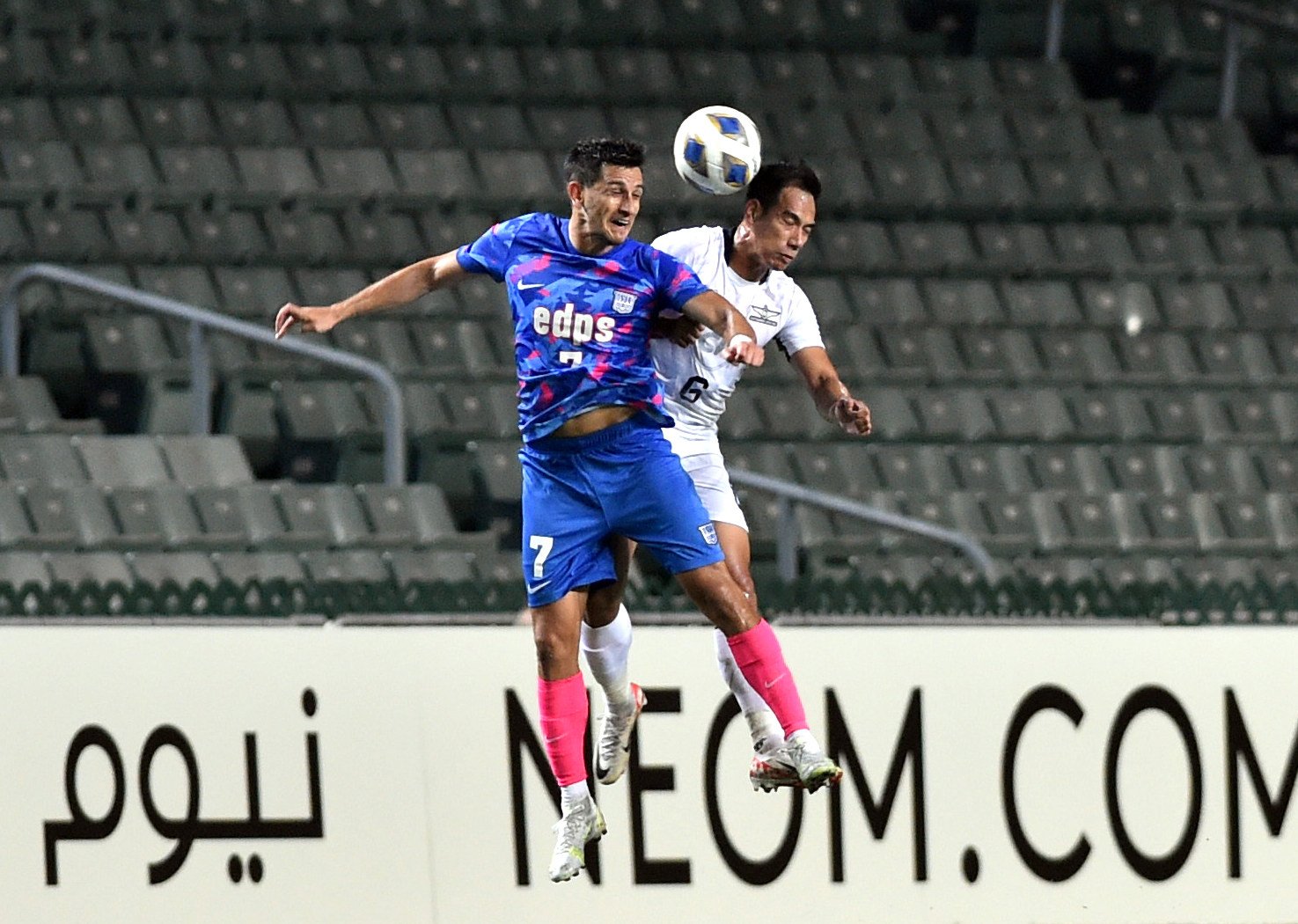 Kitchee’s Ruslan Mingazov (left) vies with Nitipong Selanon of Bangkok United at Hong Kong Stadium, where there were vast swatches of empty seats for the AFC Champions League encounter. Photo: Xinhua