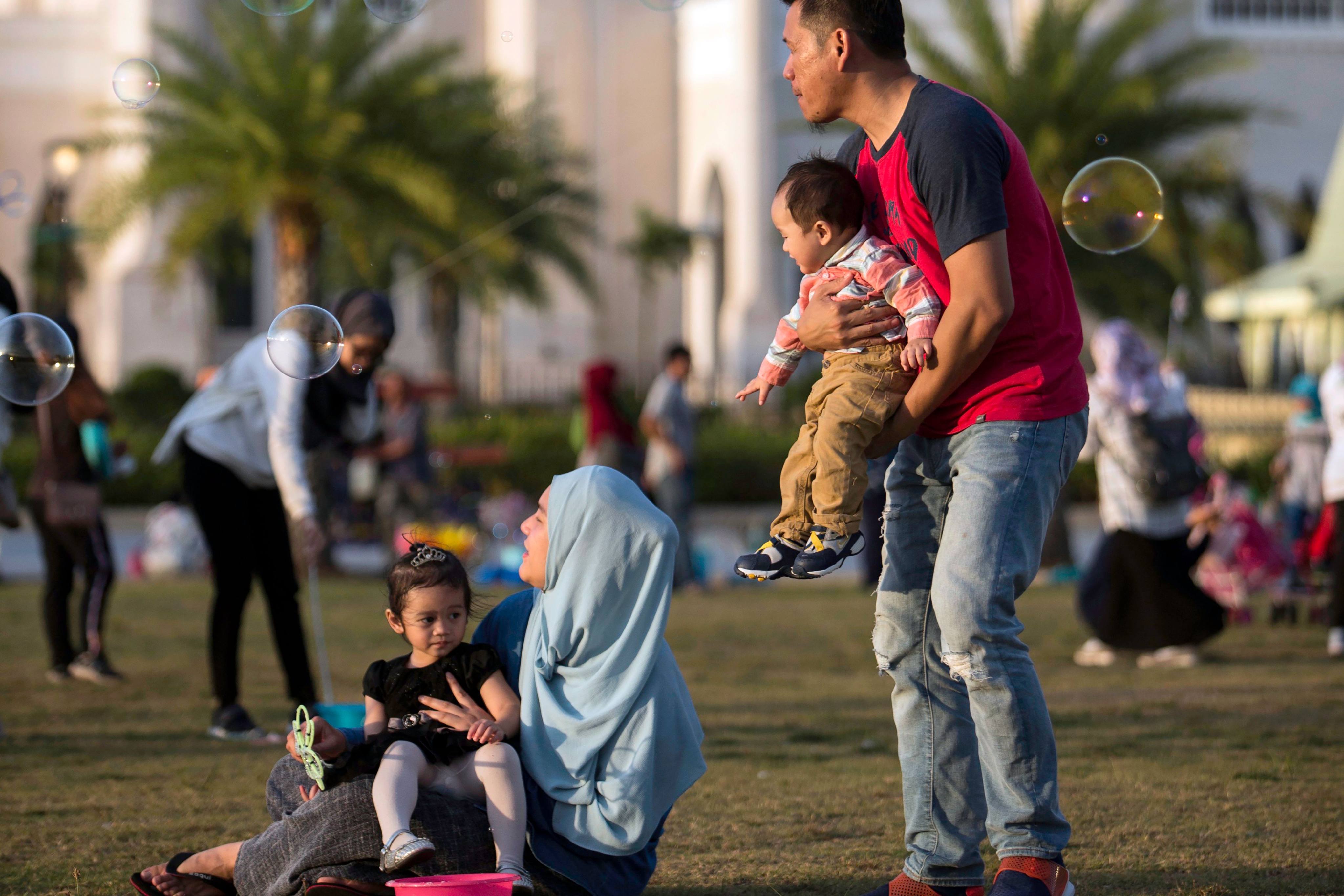 Families gather at Taman Mahkota Jubli Emas park in Bandar Seri Begawan, Brunei. Chinese workers based in the sultanate have few opportunities to mingle with the local community. Photo: AFP