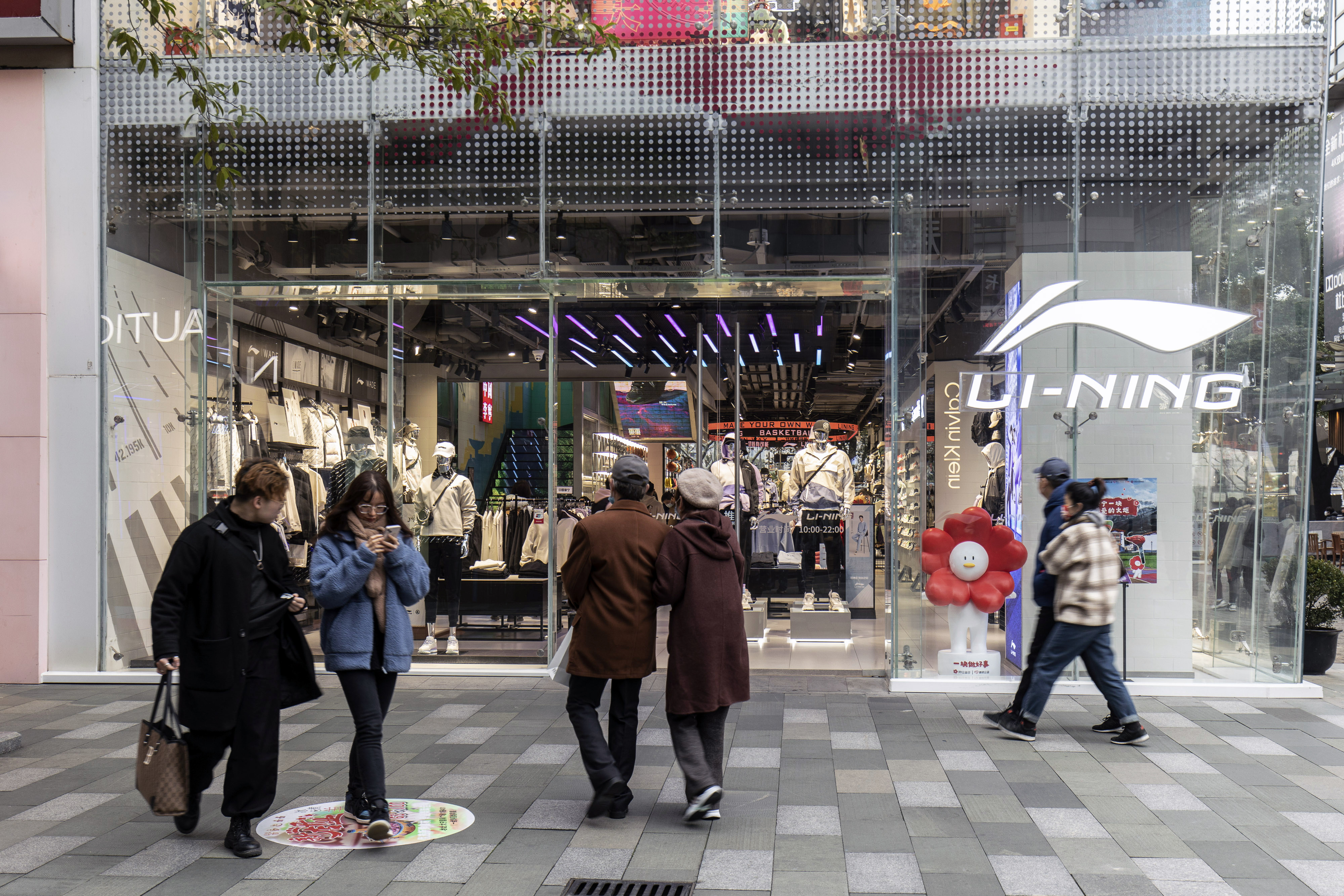 Pedestrians pass a Li Ning flagship store in Shanghai in February 2022. Photo: Bloomberg