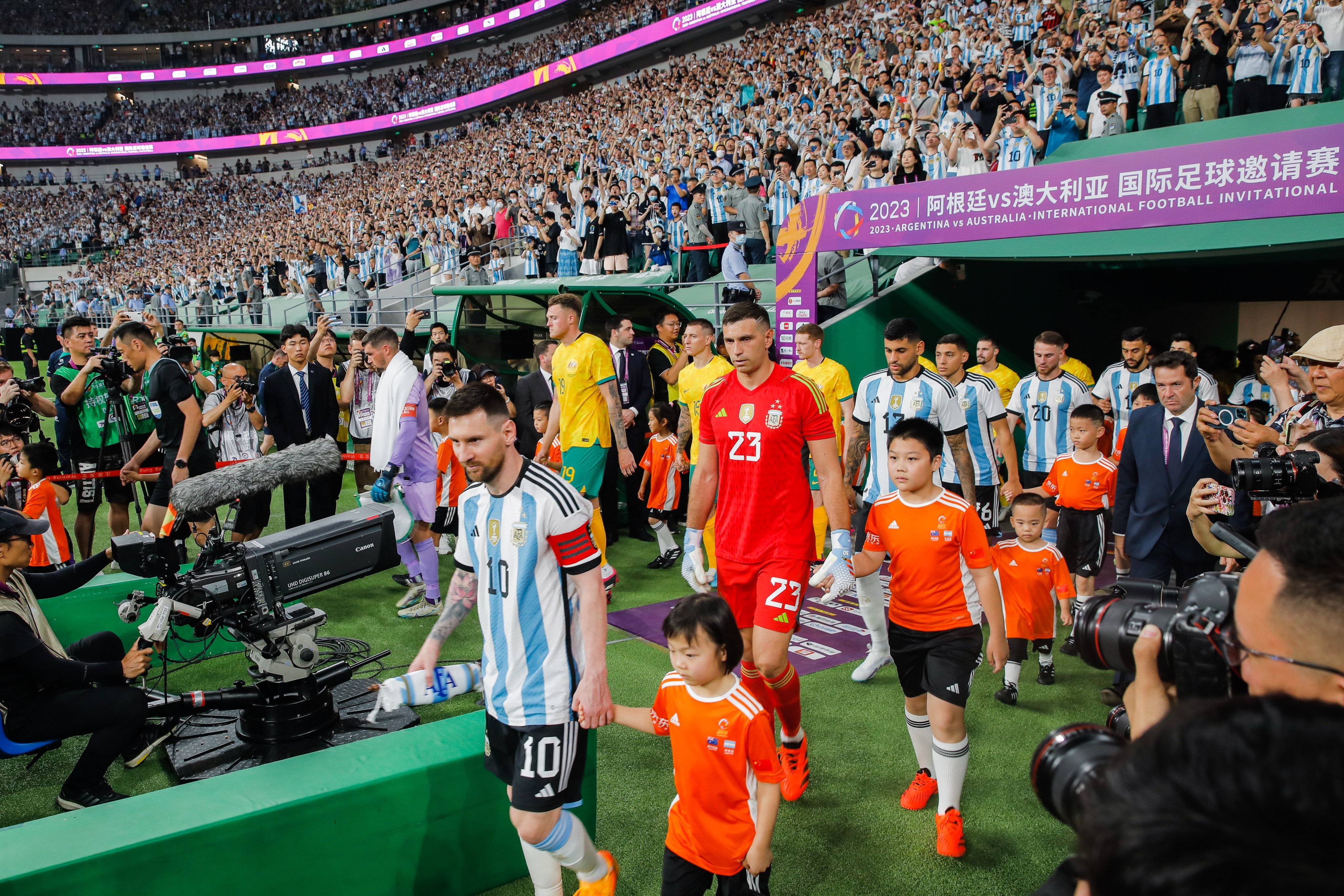 Lionel Messi leads Argentina on to the pitch for their football friendly against Australia in Beijing. Photo: EPA-EFE