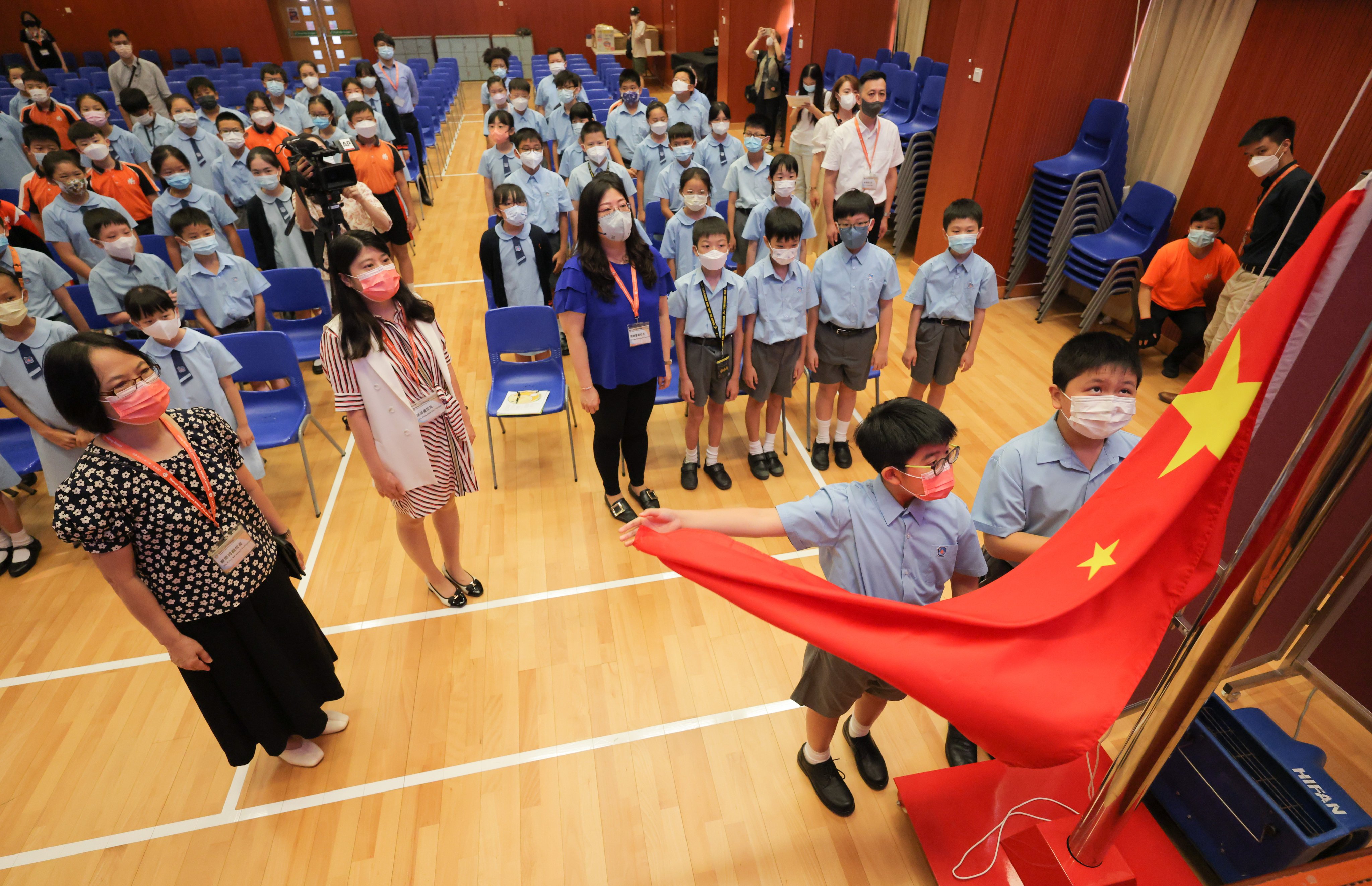 Primary school pupils raise the Chinese flag in Hong Kong. Photo: Jelly Tse