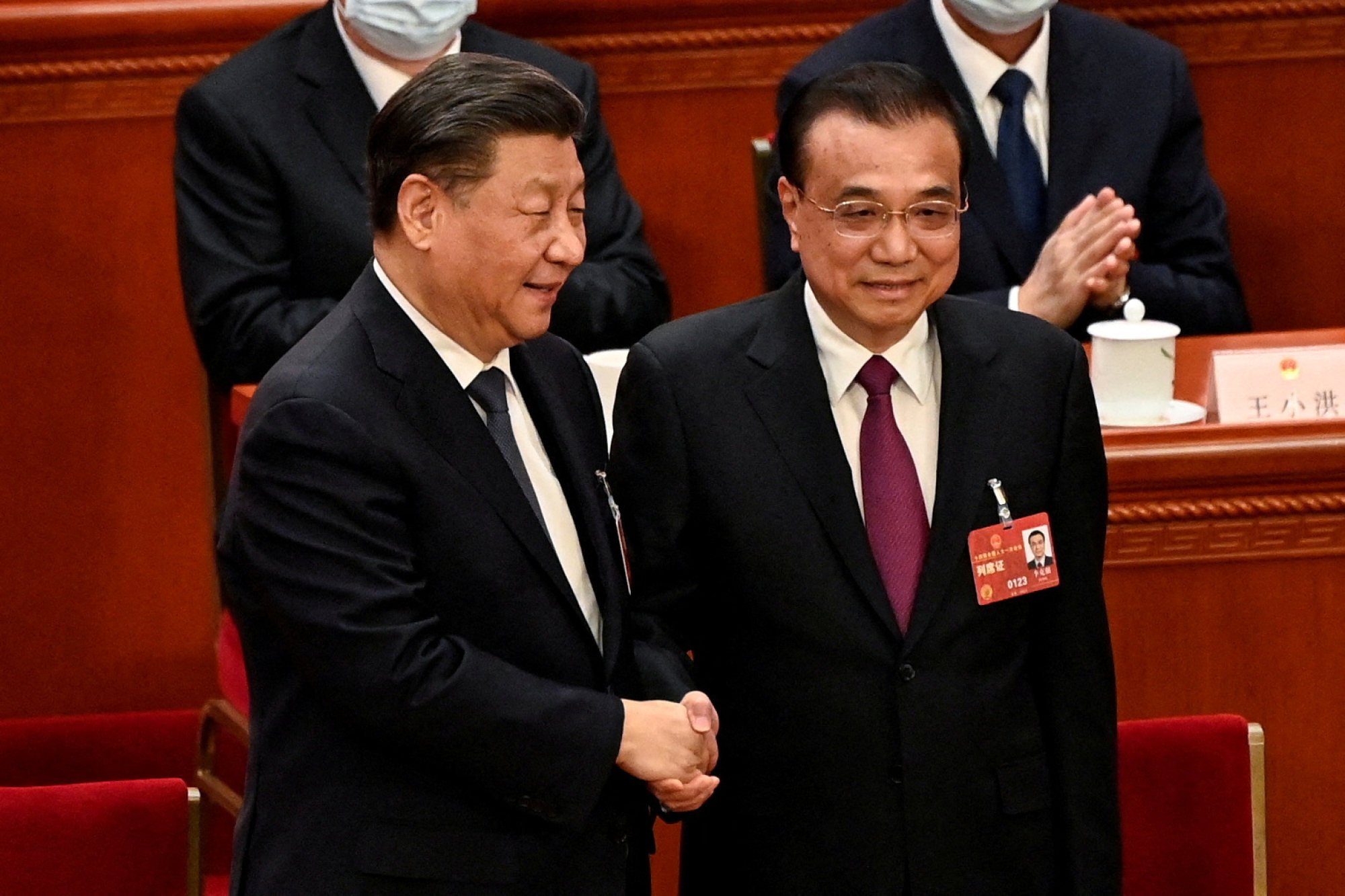 Chinese President Xi Jinping (left) shakes hands with former premier Li Keqiang during the fourth plenary session of the National People’s Congress at the Great Hall in March, which marked Li’s retirement after serving two five-year terms. Photo: Reuters