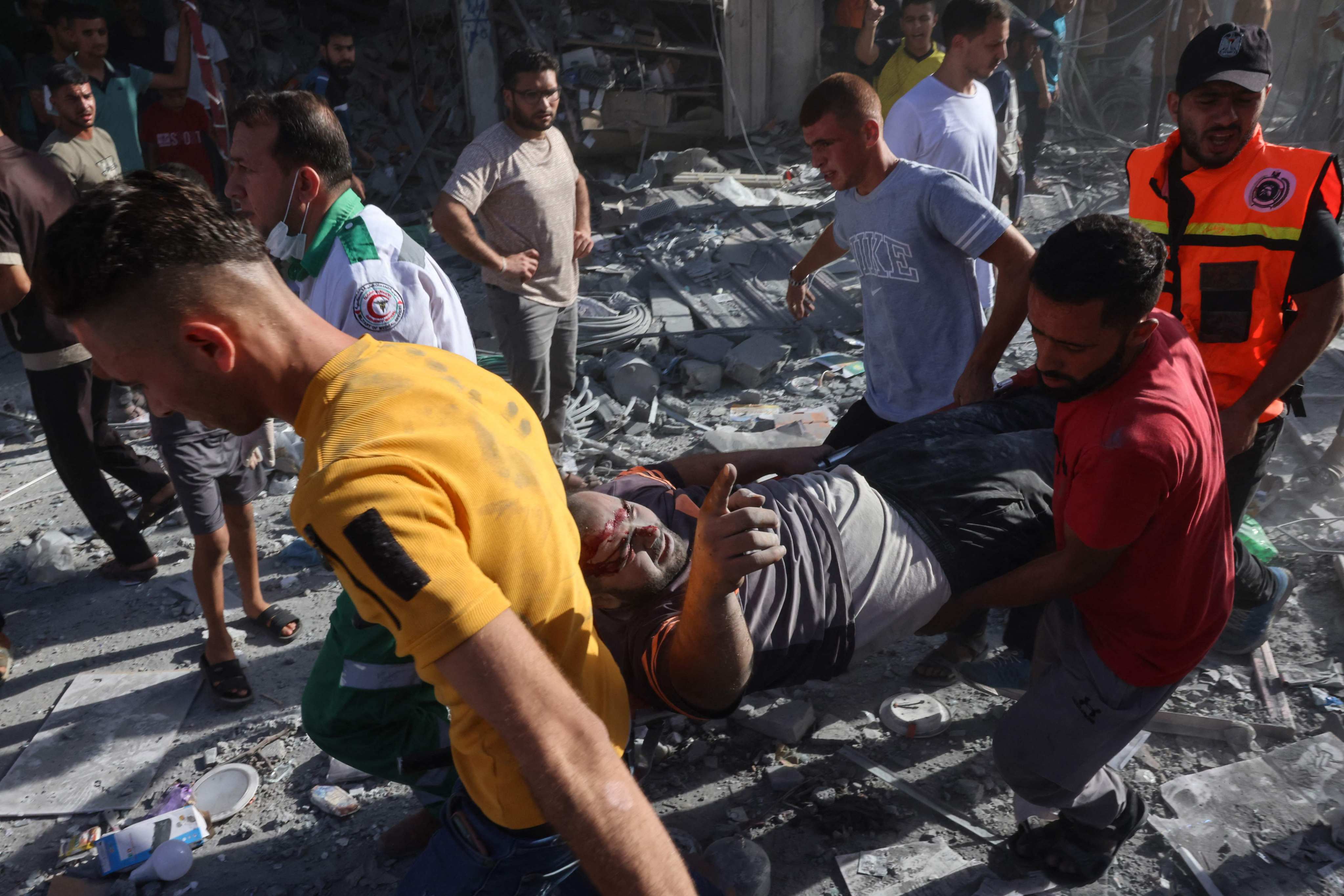 An injured man is carried on a stretcher after being found under rubble following an Israeli air strike in the southern Gaza Strip on Thursday. Photo: AFP
