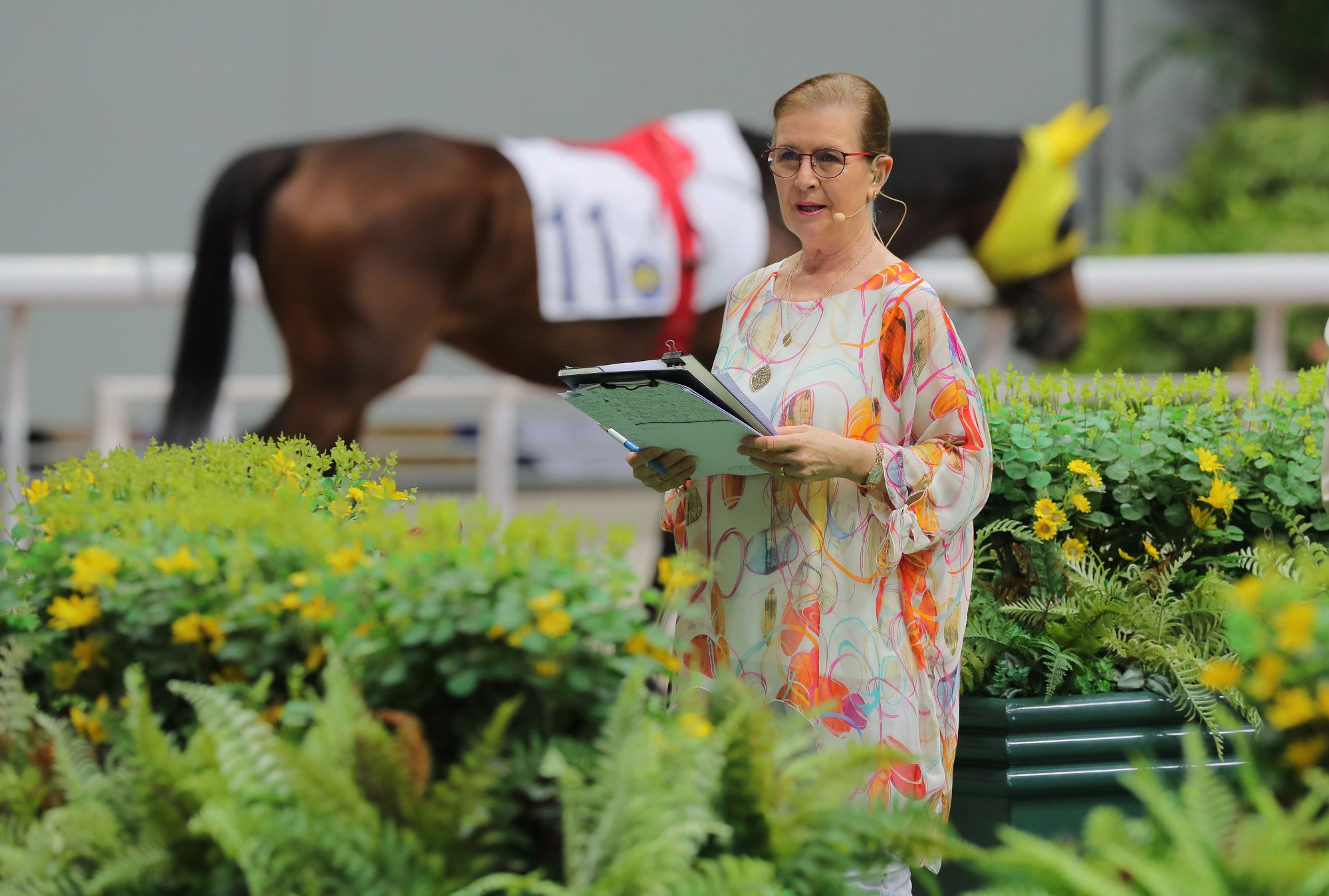 Jenny Chapman broadcasts her expert paddock insights from Sha Tin’s Parade Ring to a global television audience.