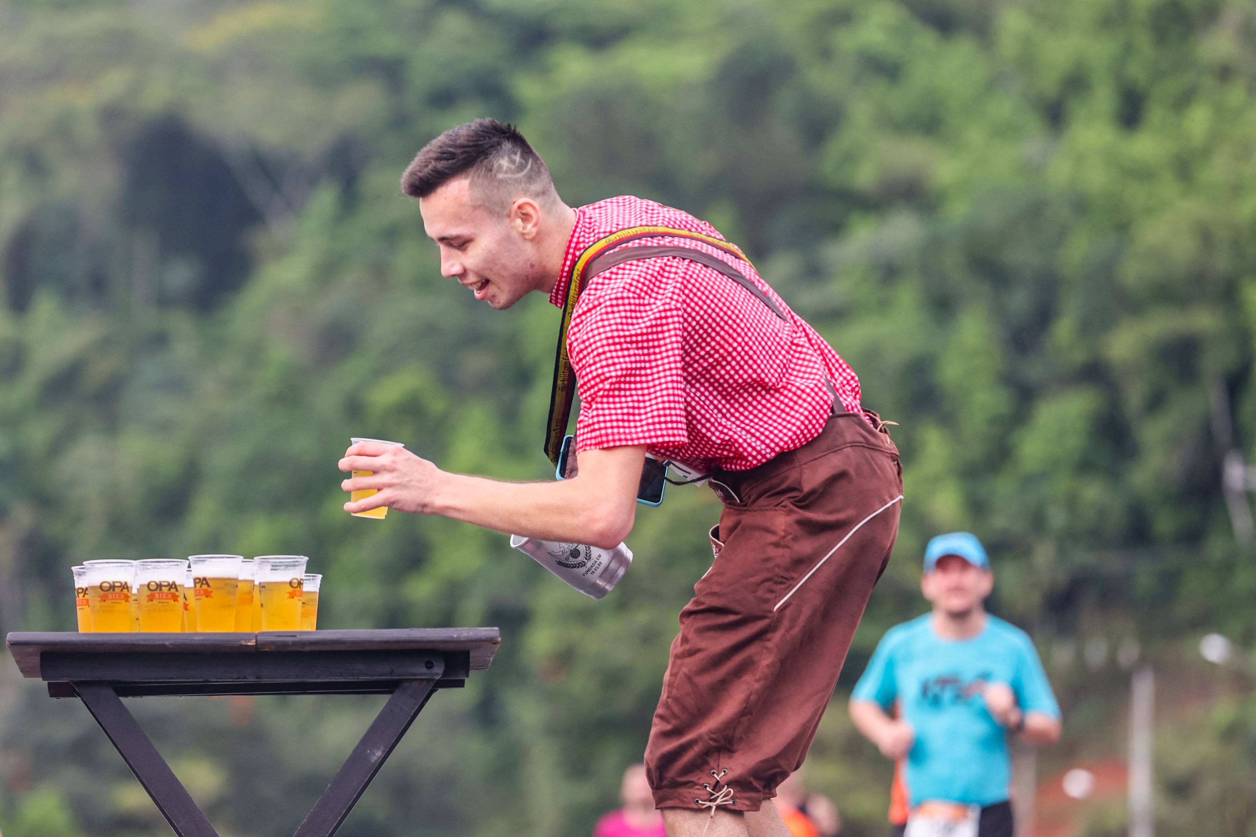 A competitor in Oktoberfest costume grabs a beer during a half-marathon race in Pomerode, one of Brazil’s oldest German settlements, on October 22. October is both Breast Cancer Awareness Month and Liver Cancer Awareness Month. Unlike breast cancer, liver cancer is something we can often control through lifestyle changes like drinking responsibly. Photo: AFP 