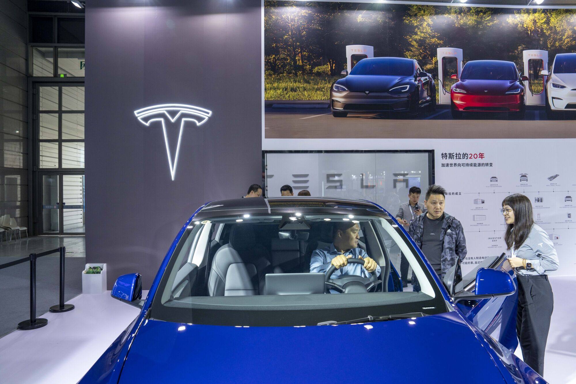 A visitor tries out a Model Y at a Tesla booth during the World Internet of Things Exposition in Wuxi, China, on October 21, 2023. Photo: Bloomberg