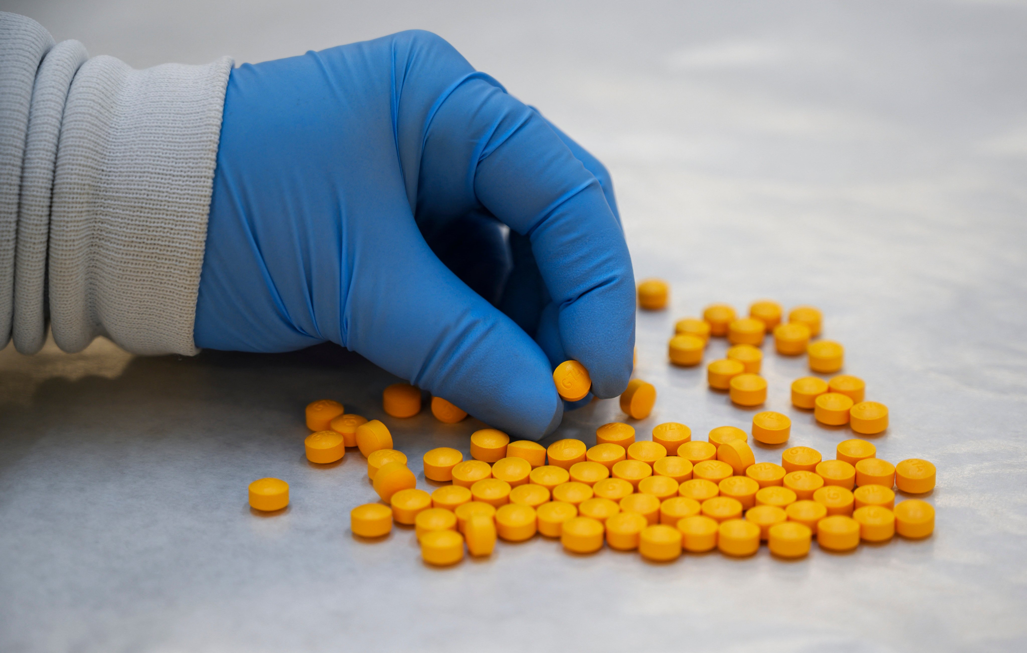 A US Drug Enforcement Administration (DEA) chemist checks confiscated fentanyl pills. Photo: AFP