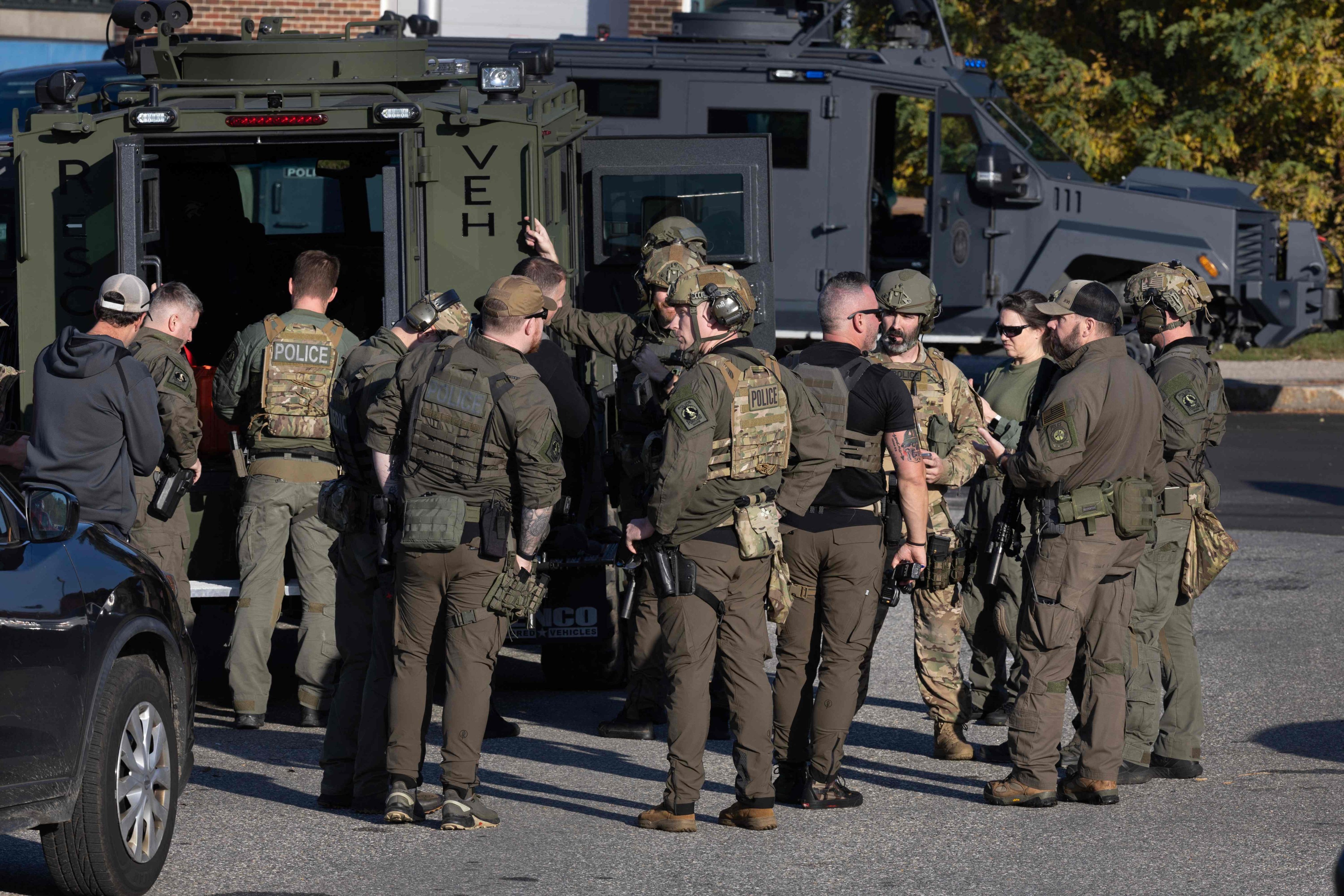 Law enforcement officials gather at the Lewiston High School as they continue a manhunt for suspect Robert Card following a mass shooting in Lewiston, Maine. Photo:  Getty Images via AFP