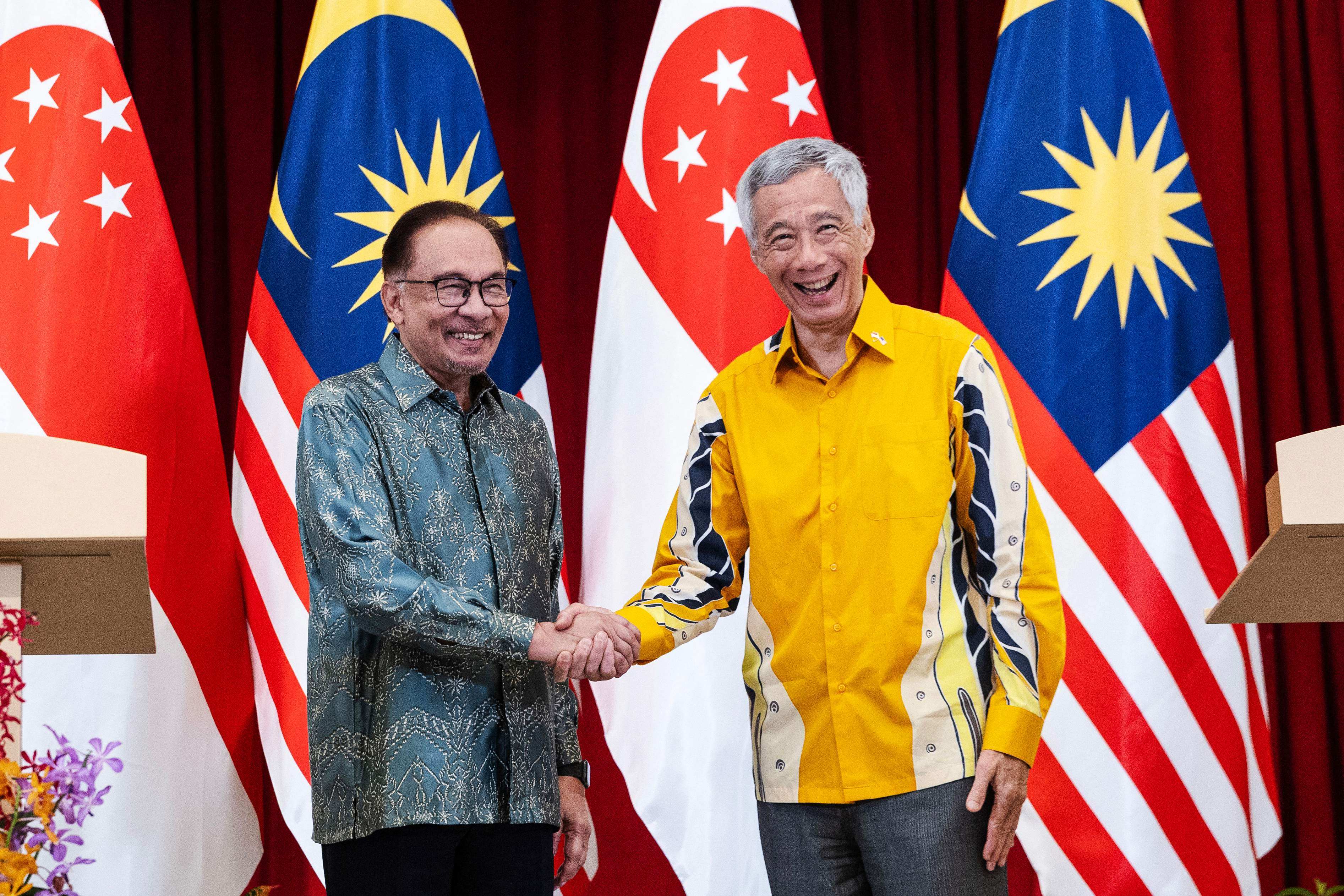 Malaysia’s Prime Minister Anwar Ibrahim (left) shakes hands with Singapore’s Prime Minister Lee Hsien Loong after a joint press conference at the Istana in Singapore on Monday. Photo: Pool/AFP