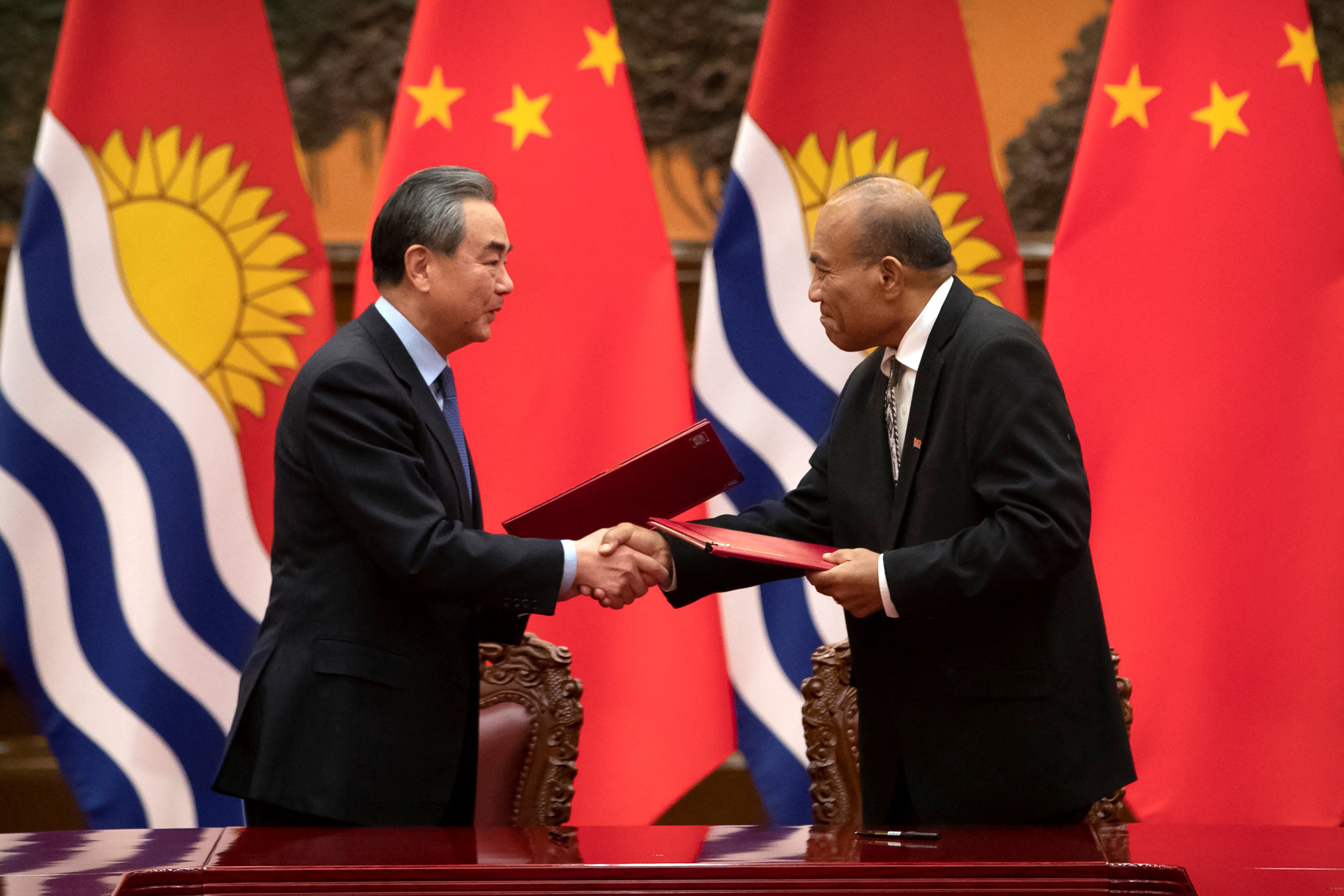 Chinese Foreign Minister Wang Yi and Kiribati’s President Taneti Maamau shake hands during a signing ceremony at the Great Hall of the People in Beijing in January 2020. Photo: Reuters