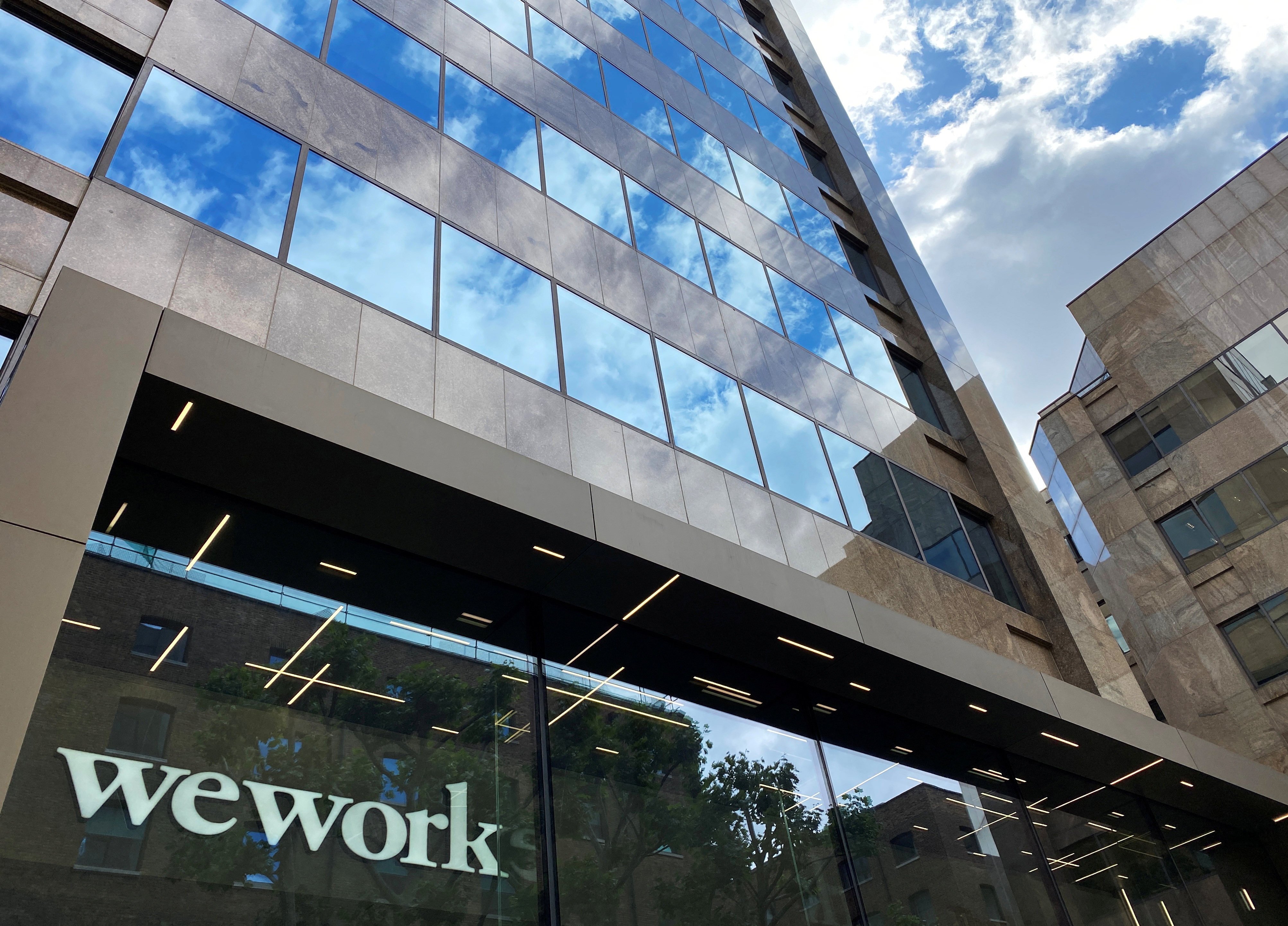 The logo of WeWork is seen in the window of an office building in London on July 3, 2020. Photo: Reuters