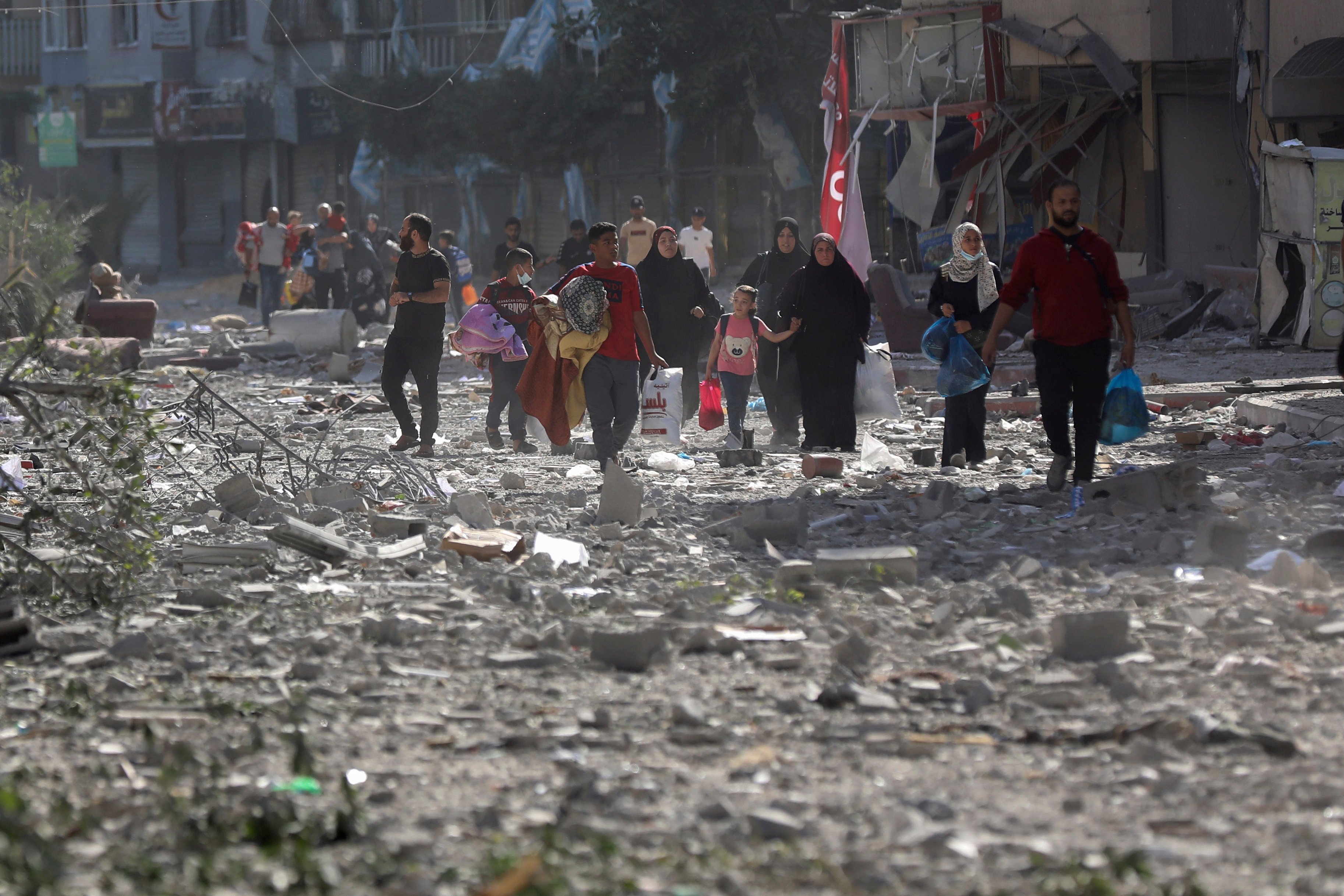 Palestinians leave their homes after an Israeli bombardment of Gaza City. Photo: AP