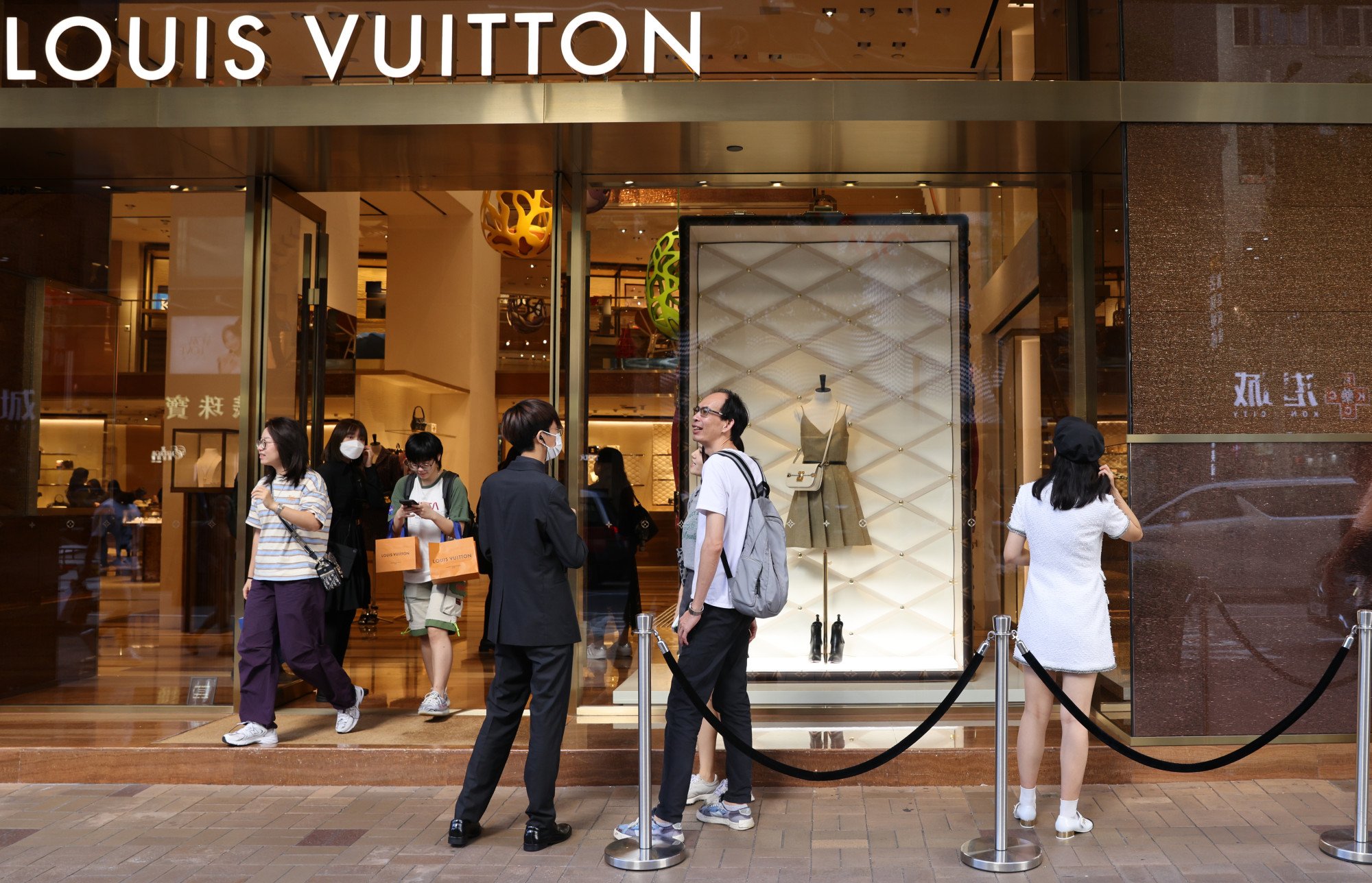 SHANGHAI, CHINA - JUNE 28, 2023 - People take photos of Louis Vuitton  coffee they just bought at the entrance of a Louis Vuitton cafe in Shanghai,  China, June 28, 2023. Recently