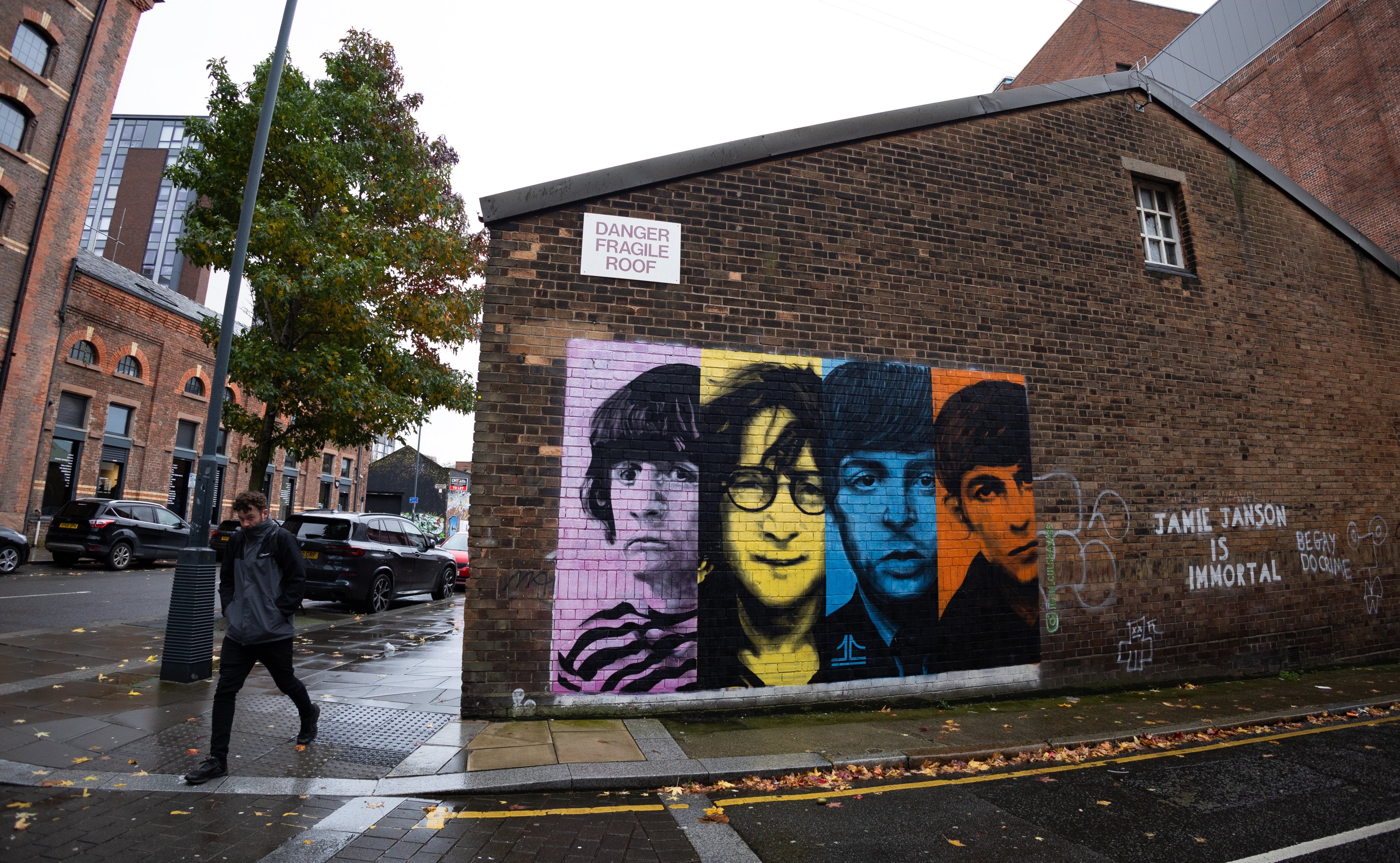 A person walks past a mural of the Beatles in Liverpool on Thursday. Photo: EPA-EFE