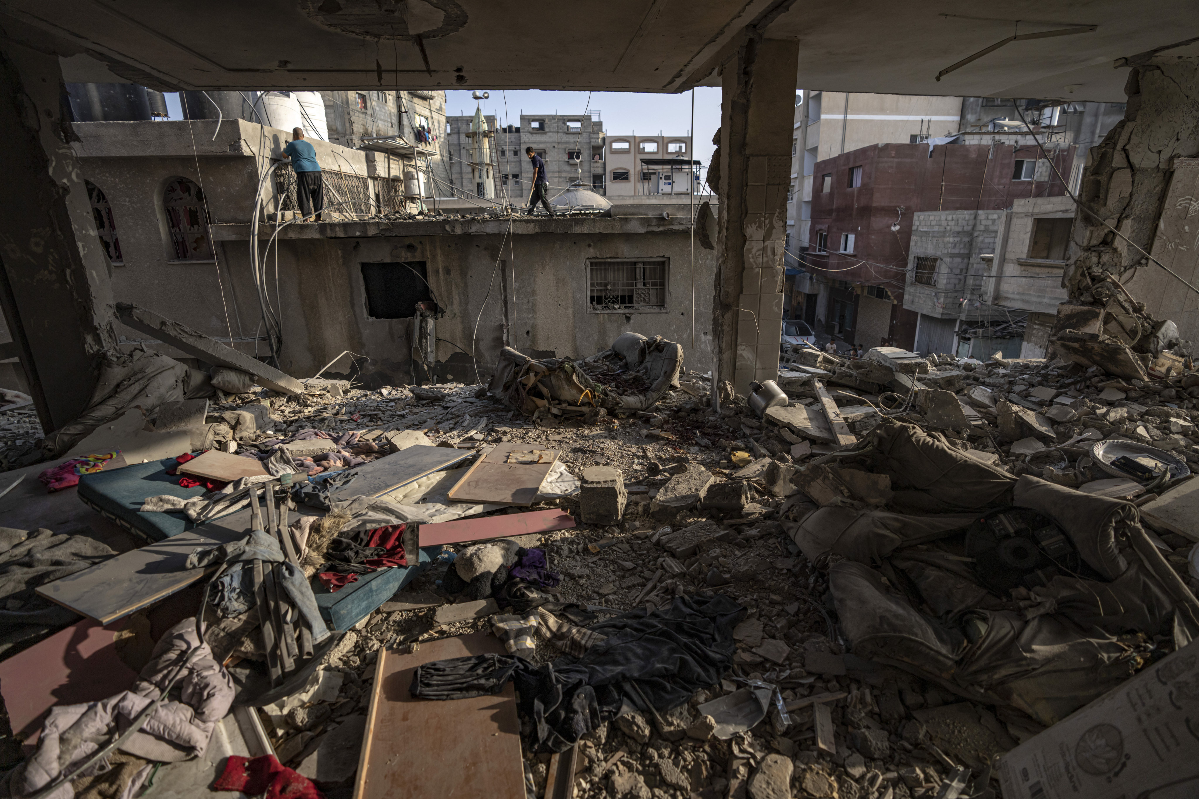 A Palestinian checks the destruction after Israeli strikes on the Gaza Strip in Khan Younis on Friday. Photo: AP