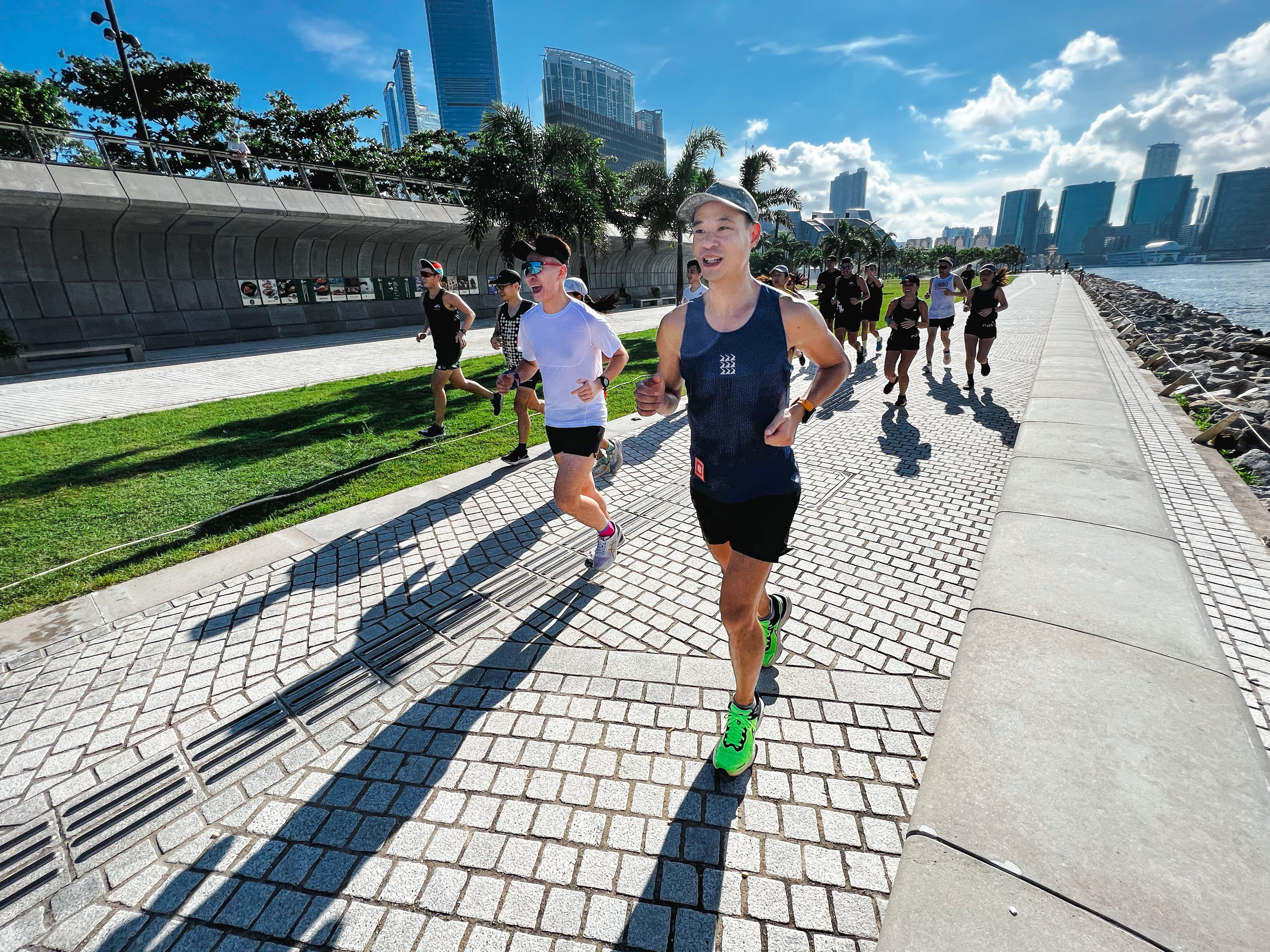 Wazup Running Club founder Andrew Wong (right) leads one of the club’s runs along the Hong Kong waterfront. Photo: Handout