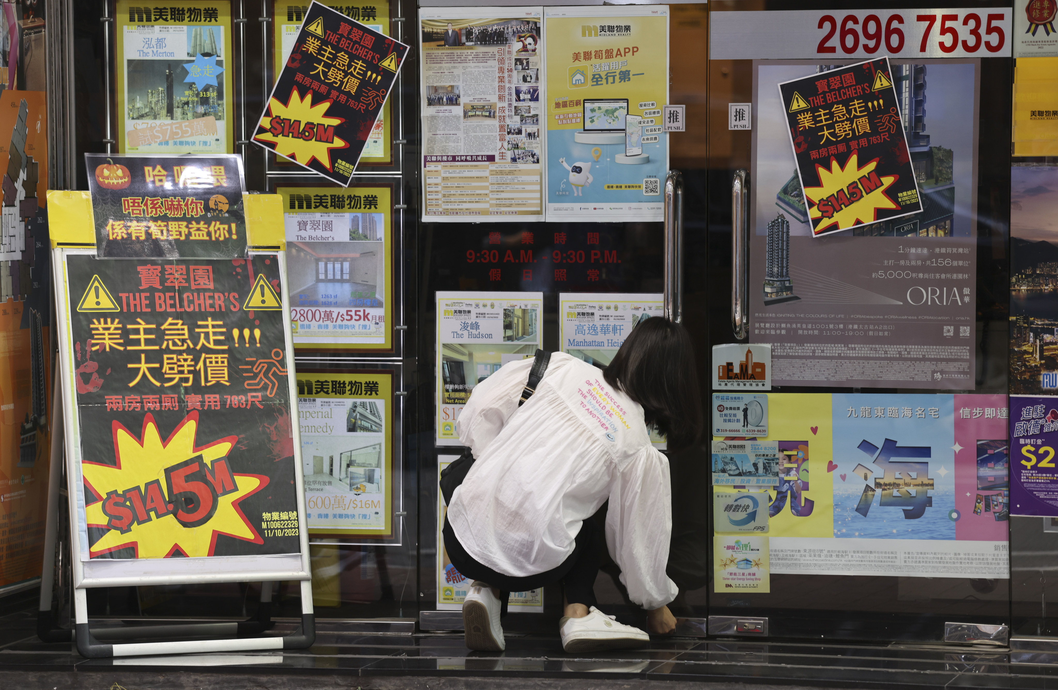 An agent opens a real estate office in Kennedy Town, Hong Kong, on November 2, 2023. Photo: Yik Yeung-man