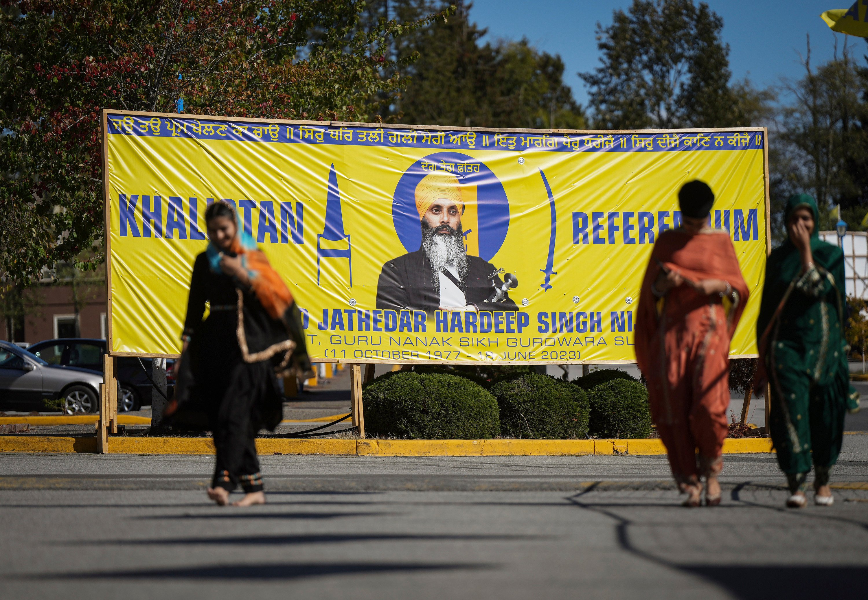 FILE - A photograph of late temple president Hardeep Singh Nijjar is seen on a banner outside the Guru Nanak Sikh Gurdwara Sahib in Surrey, British Columbia, on Sept. 18, 2023, where temple president Hardeep Singh Nijjar was gunned down in his vehicle while leaving the temple parking lot in June. Indian and Canadian officials have been in contact “at various levels” following a confrontation over Canadian accusations that India may have been involved in the killing of a Sikh separatist leader in suburban Vancouver, an official in New Delhi said Thursday Oct. 12, 2023. (Darryl Dyck/The Canadian Press via AP, File)