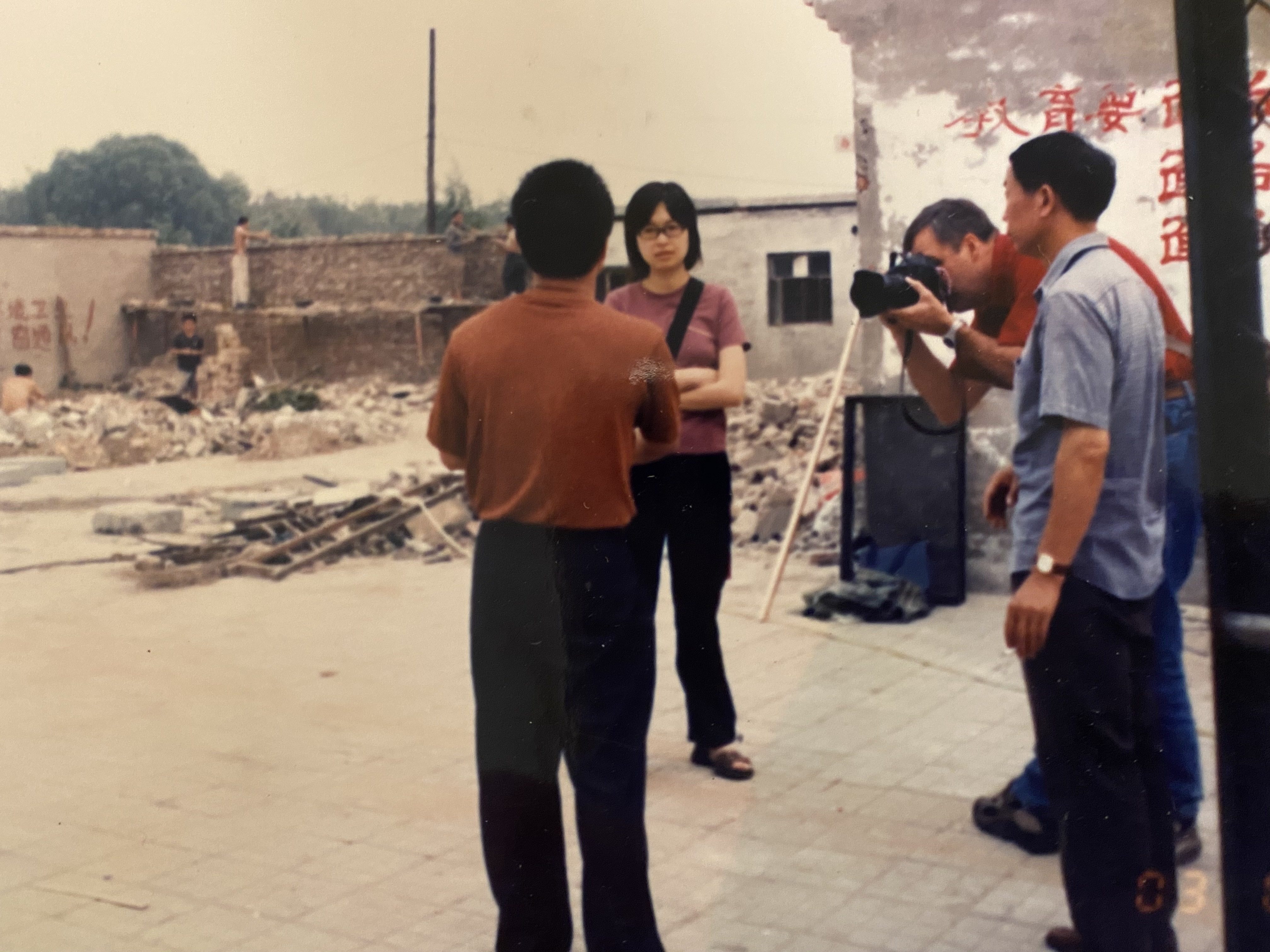 South China Morning Post journalist Josephine Ma interviews victims of demolition in Beijing in 2003, with SCMP photographer Mark Ralston. 