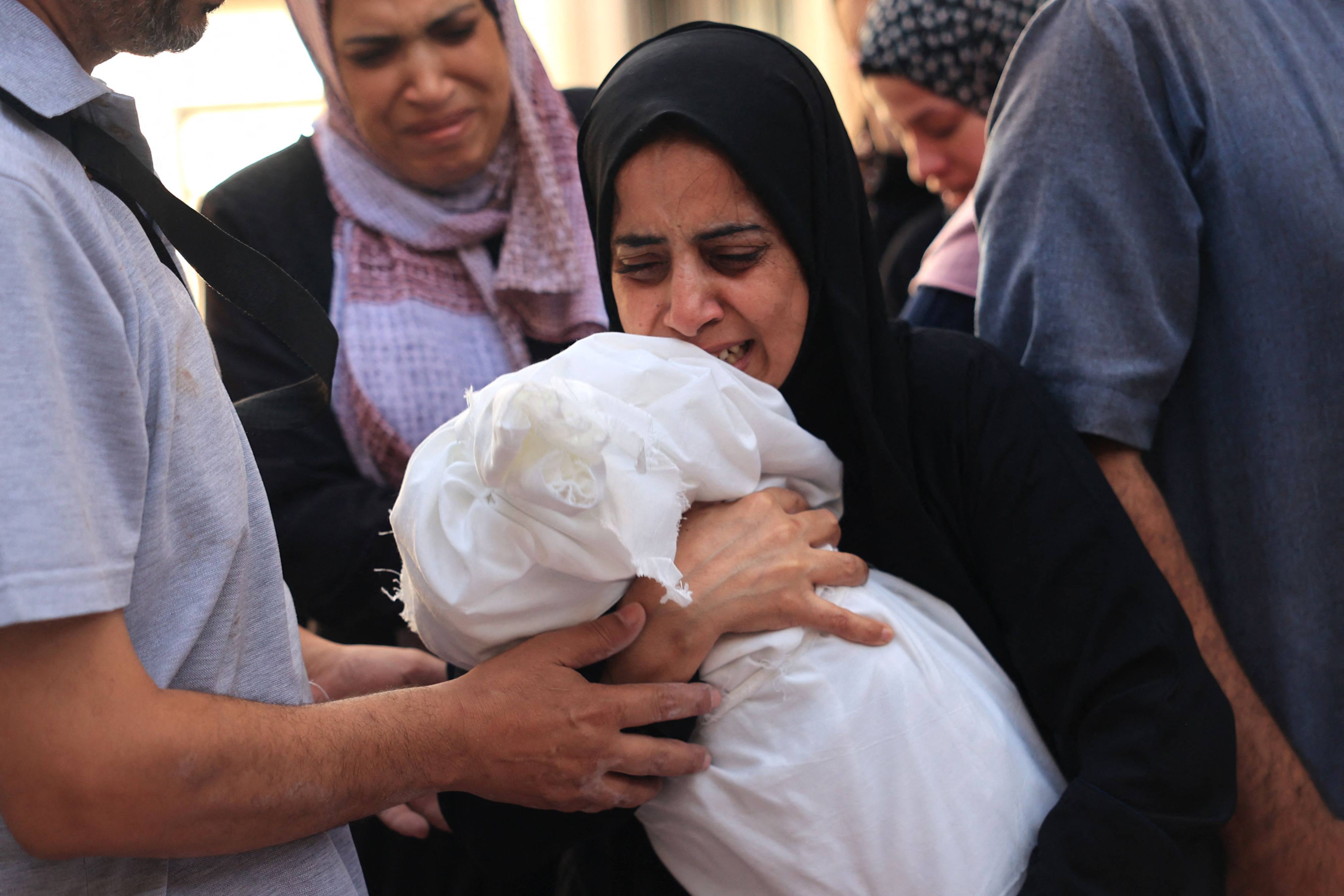 Relatives mourn the death of 8-month-old Ahmed Barhom at a funeral for members of the same family killed in Israeli bombardment in Rafah,Gaza Strip on Monday. Photo: AFP
