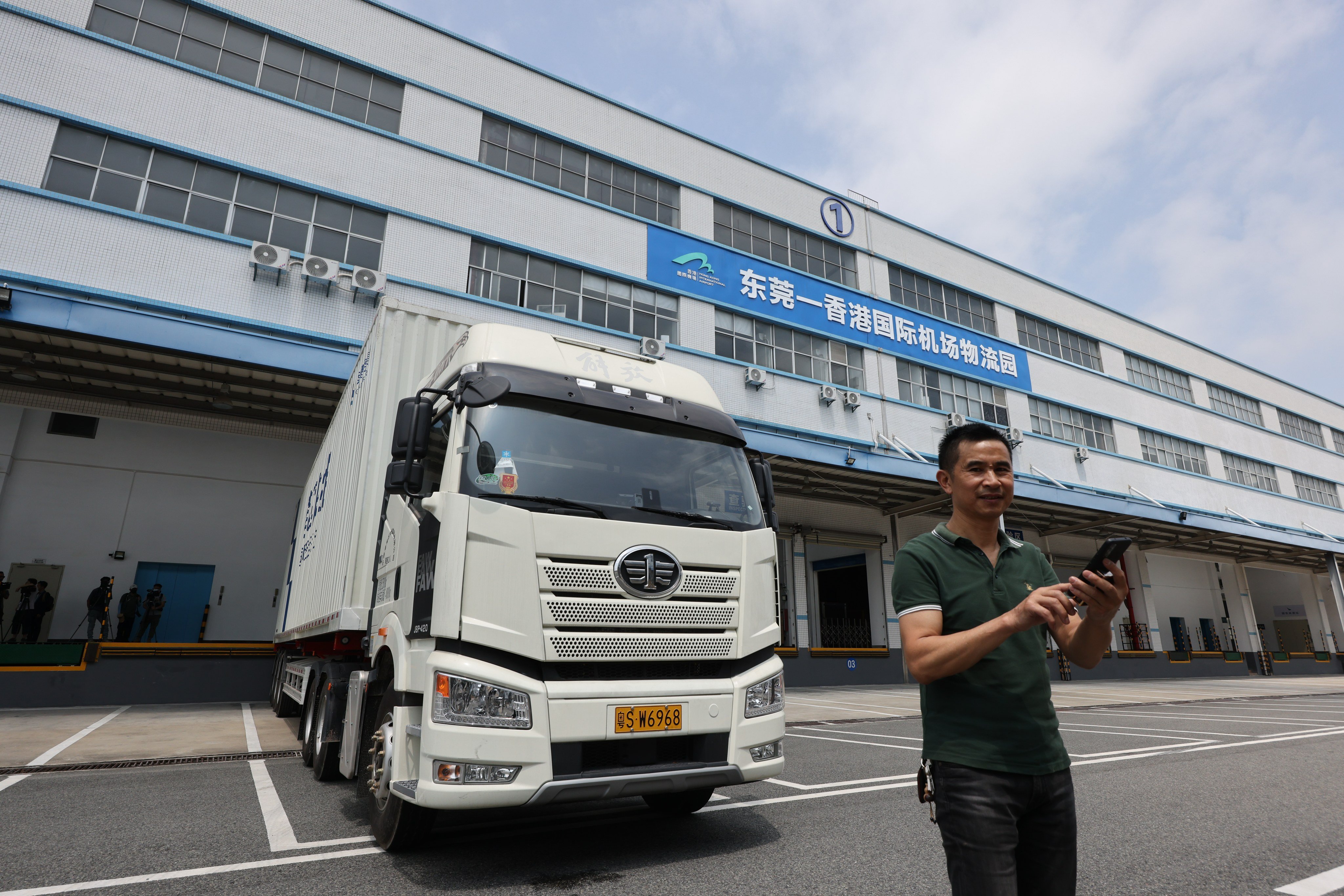 A mainland truck driver poses in front of the Hong Kong International Airport Logistics Park pilot facility in Dongguan on May 17, 2023. Photo: May Tse