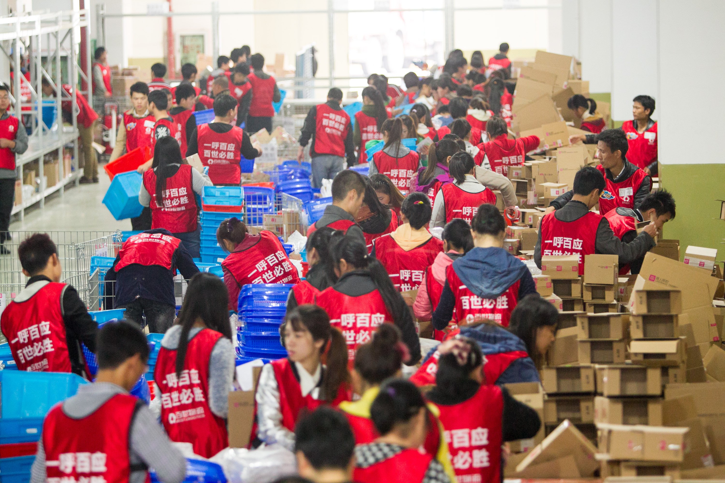 Chinese workers sort out parcels from online shopping at a warehouse of Best Logistics in Shanghai, China. Photo: Handout 

,